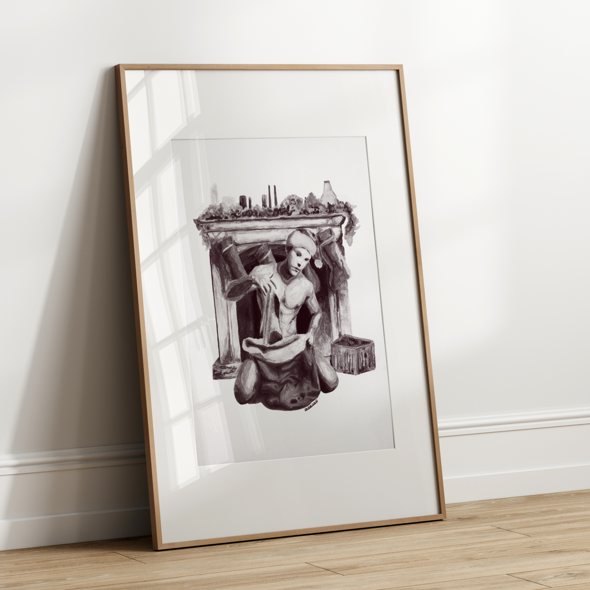 Framed black and white artwork leaning against a white wall.