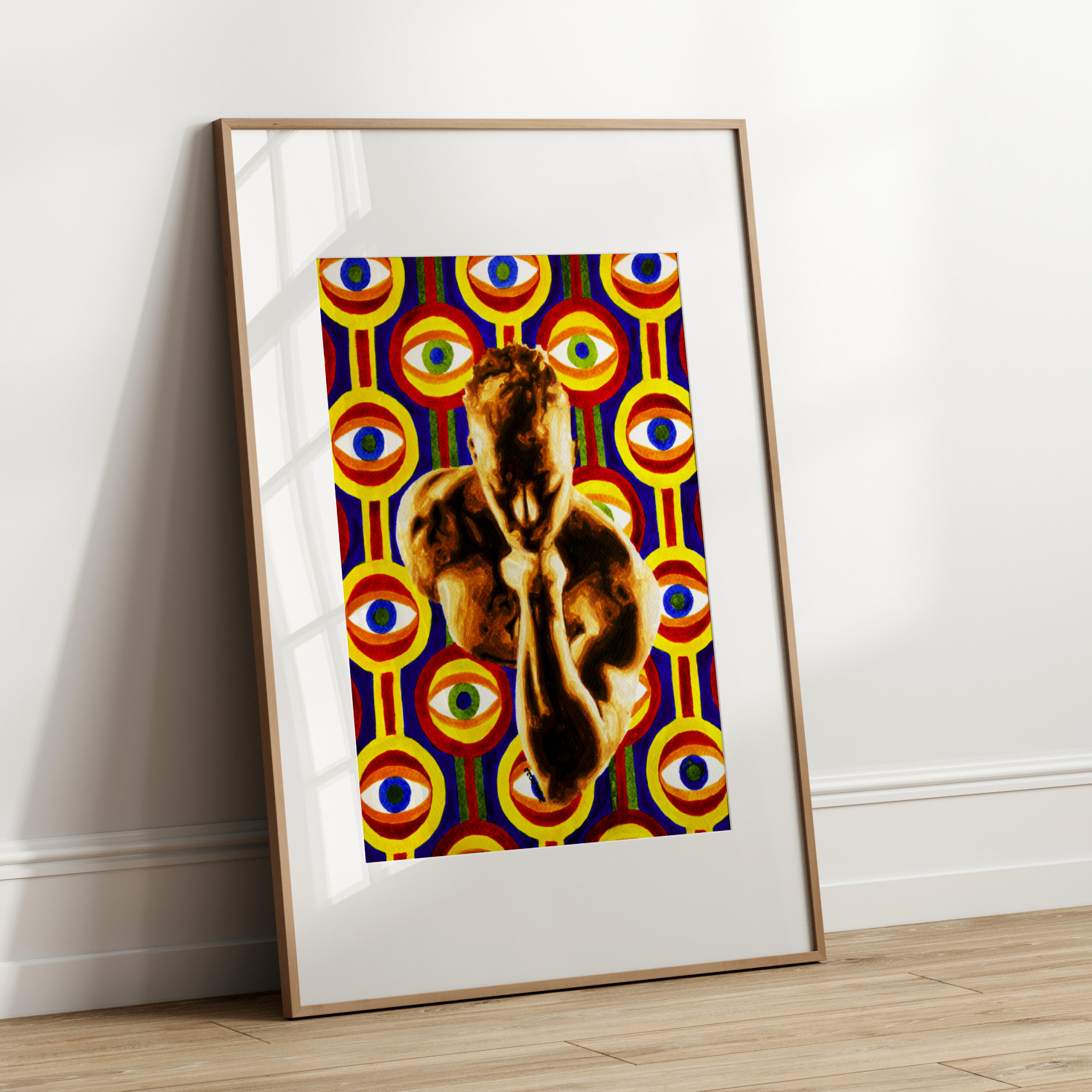 Framed artwork of a goat on a colorful abstract background leaning against a white wall.