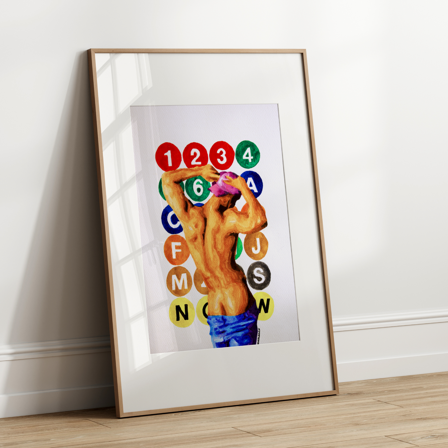 Framed artwork with a colorful design on a white wall