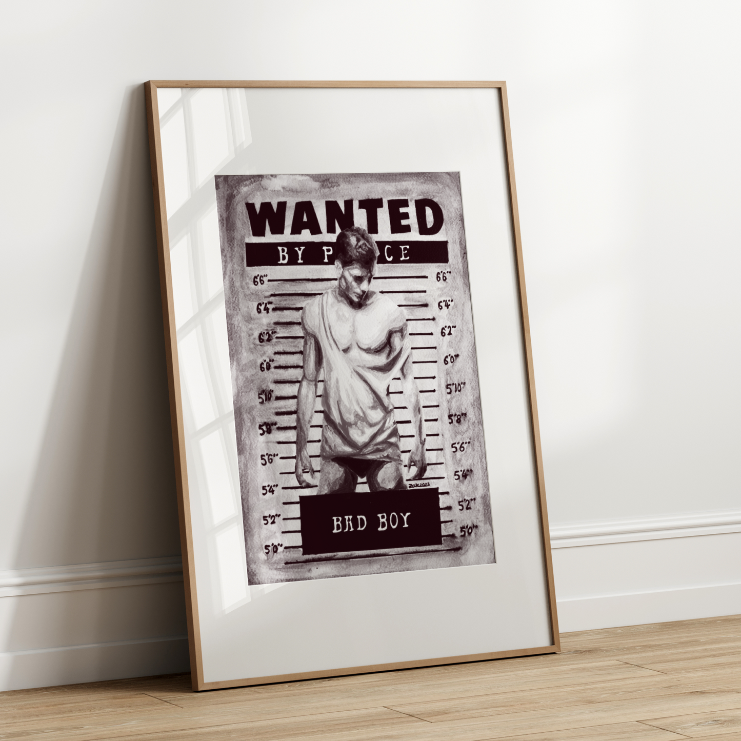 Framed 'Wanted' poster on a white wall