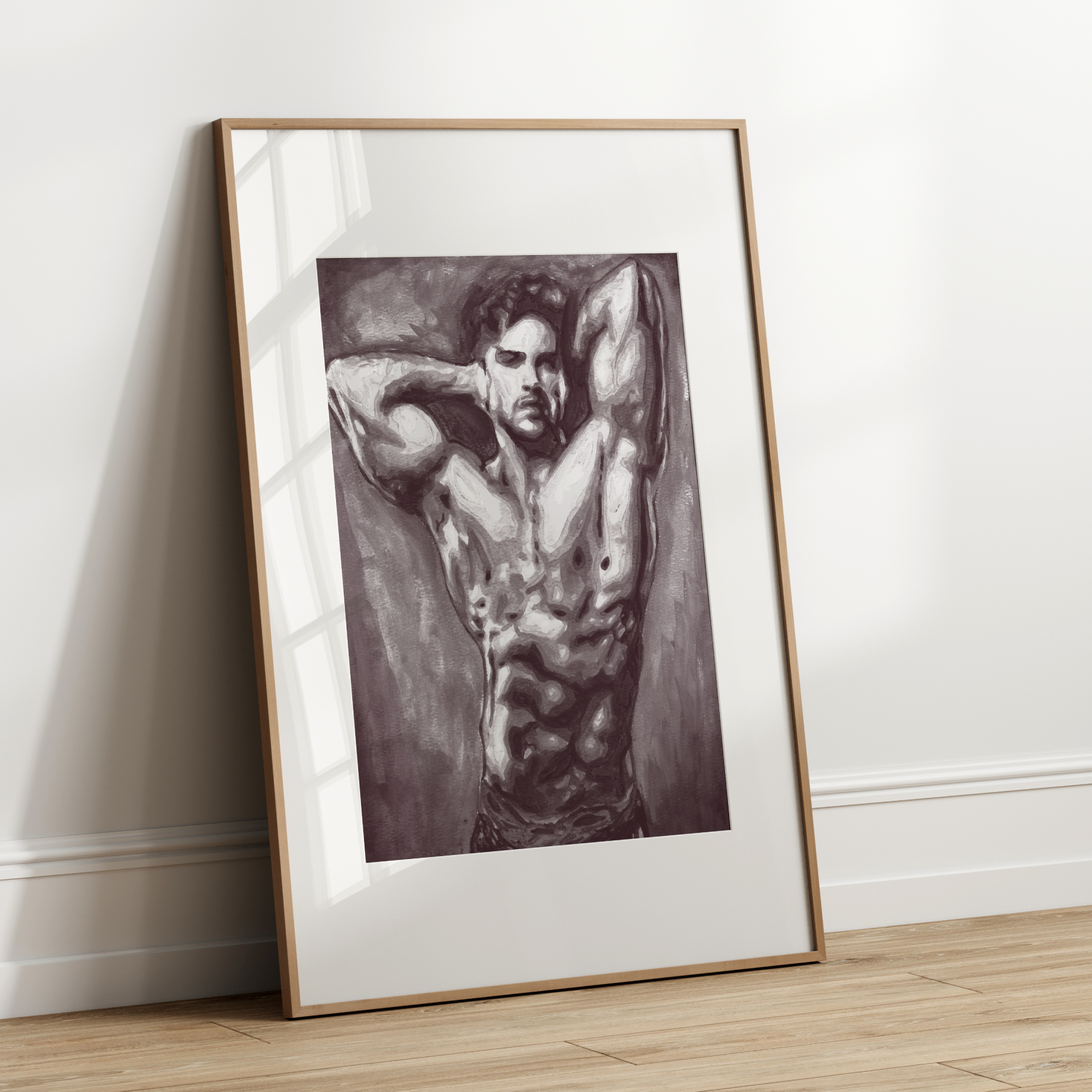 Framed artwork of a shirtless man against a white wall