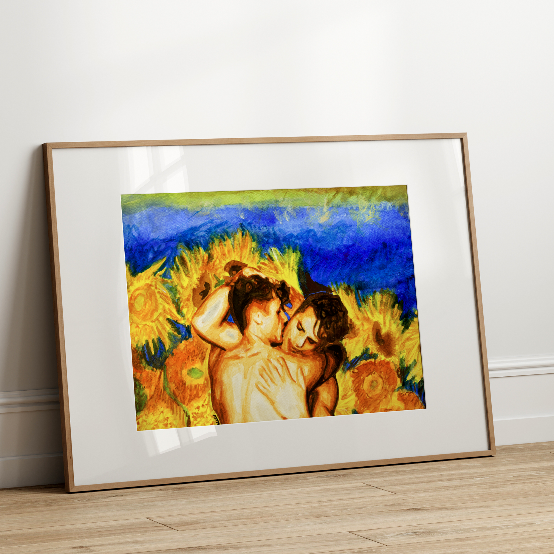Framed artwork of two people embracing with sunflowers against a blue sky on a white wall.