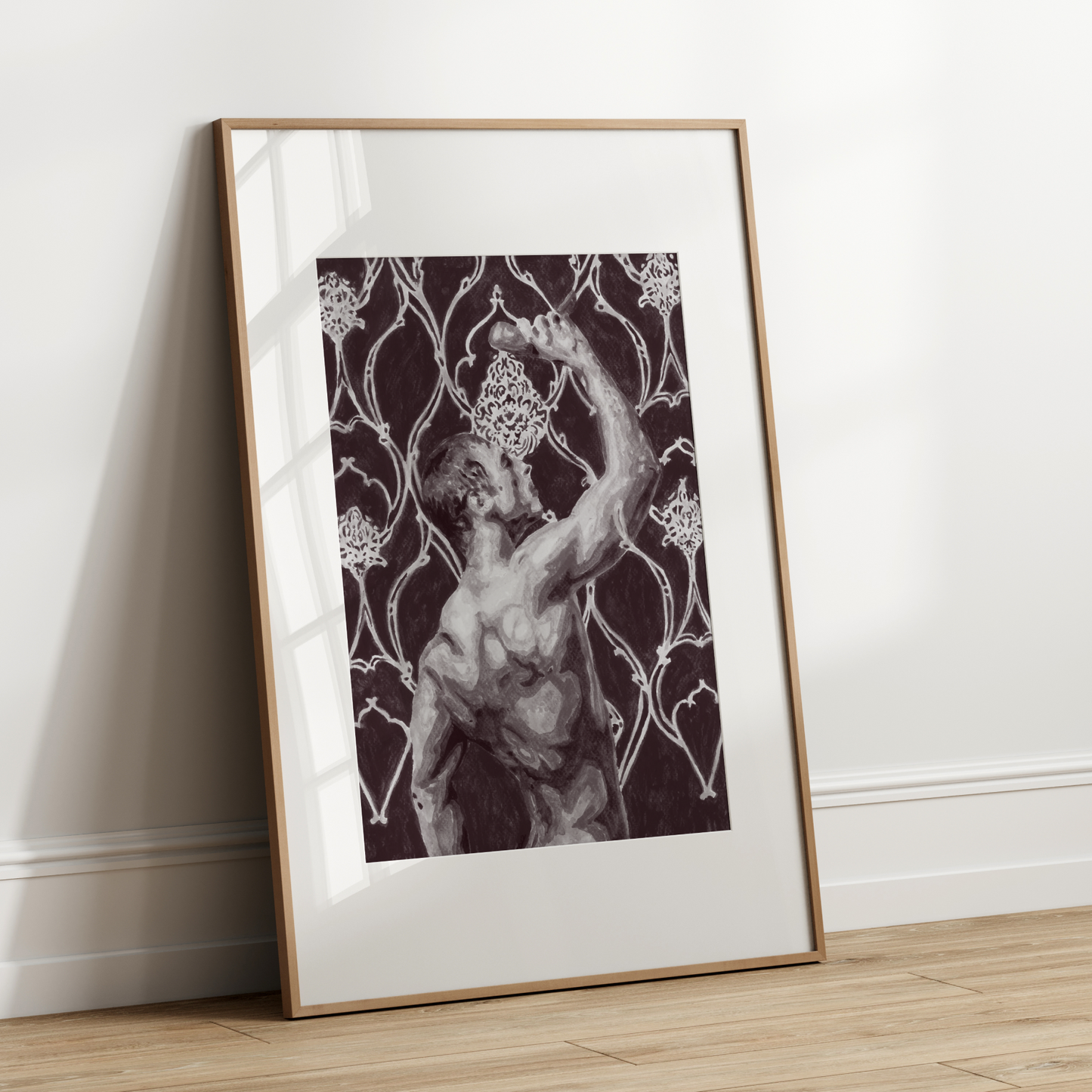 Framed artwork of a classical statue against a floral pattern on a white wall.
