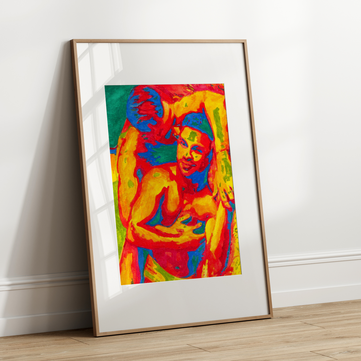 Framed colorful artwork of gay couple kissing on a white wall