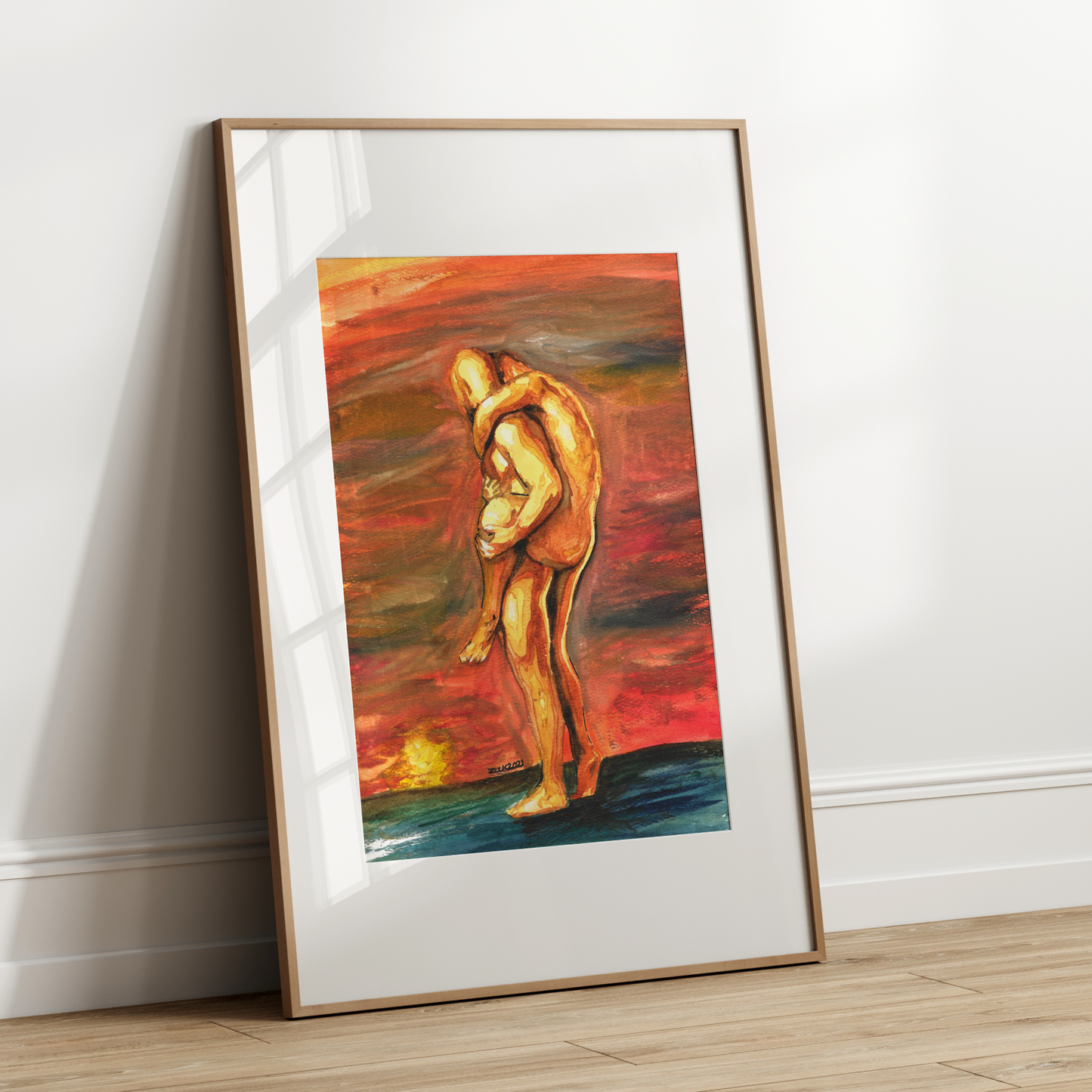 Framed abstract artwork of two figures embracing on a white wall.