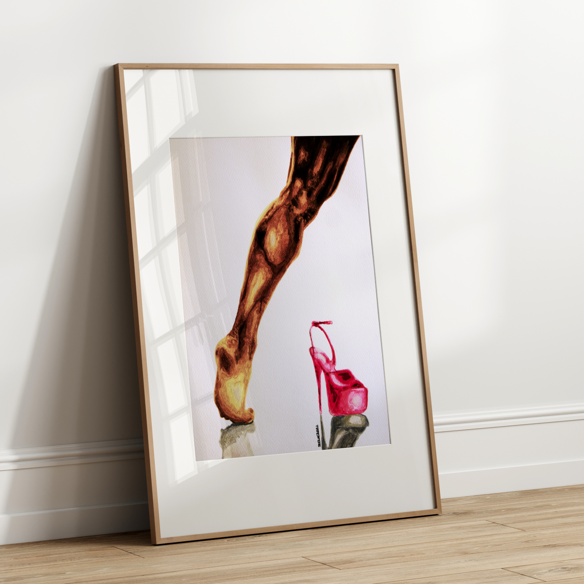 Framed artwork of a leg and red high heel shoe on a white wall.