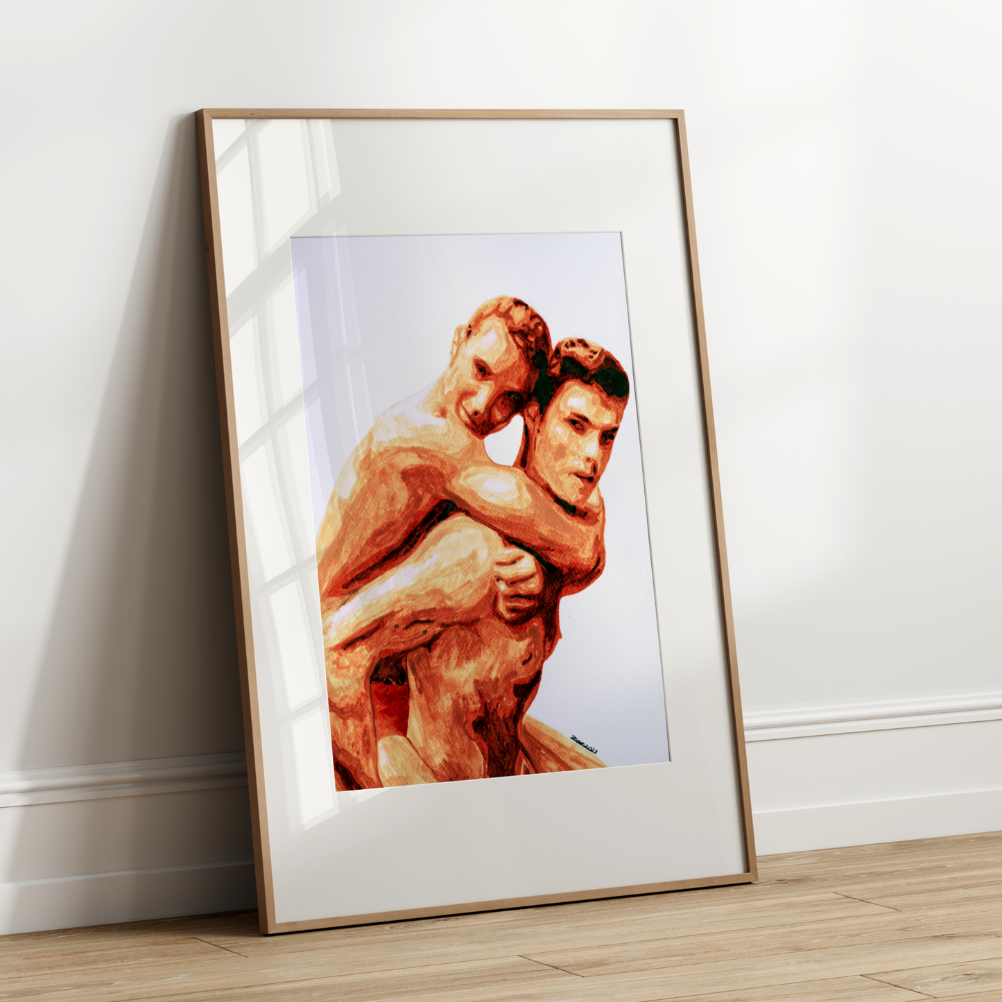 Framed artwork of two muscular figures embracing on a white wall.