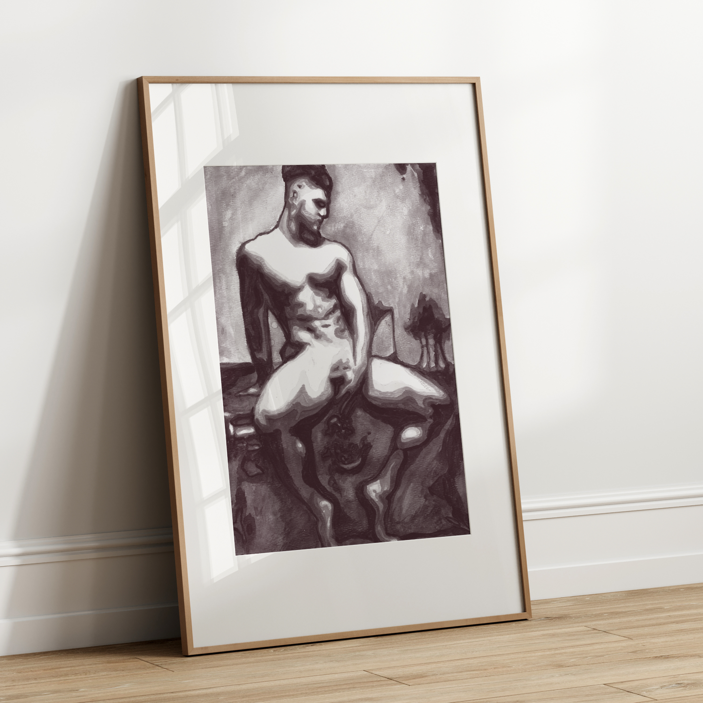 Framed black and white artwork of a nude figure leaning against a white wall.