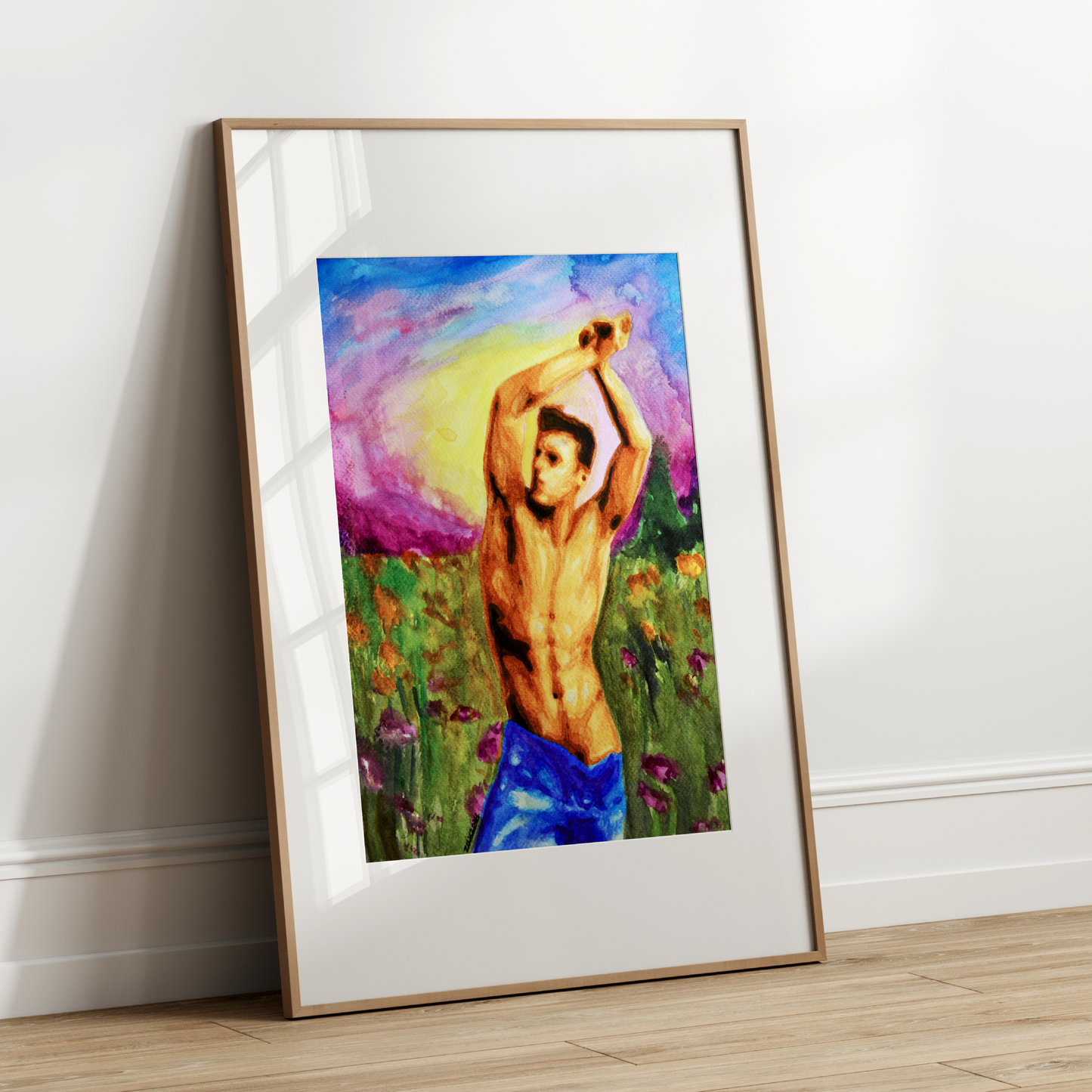 Framed artwork of a shirtless man in a field against a white wall.