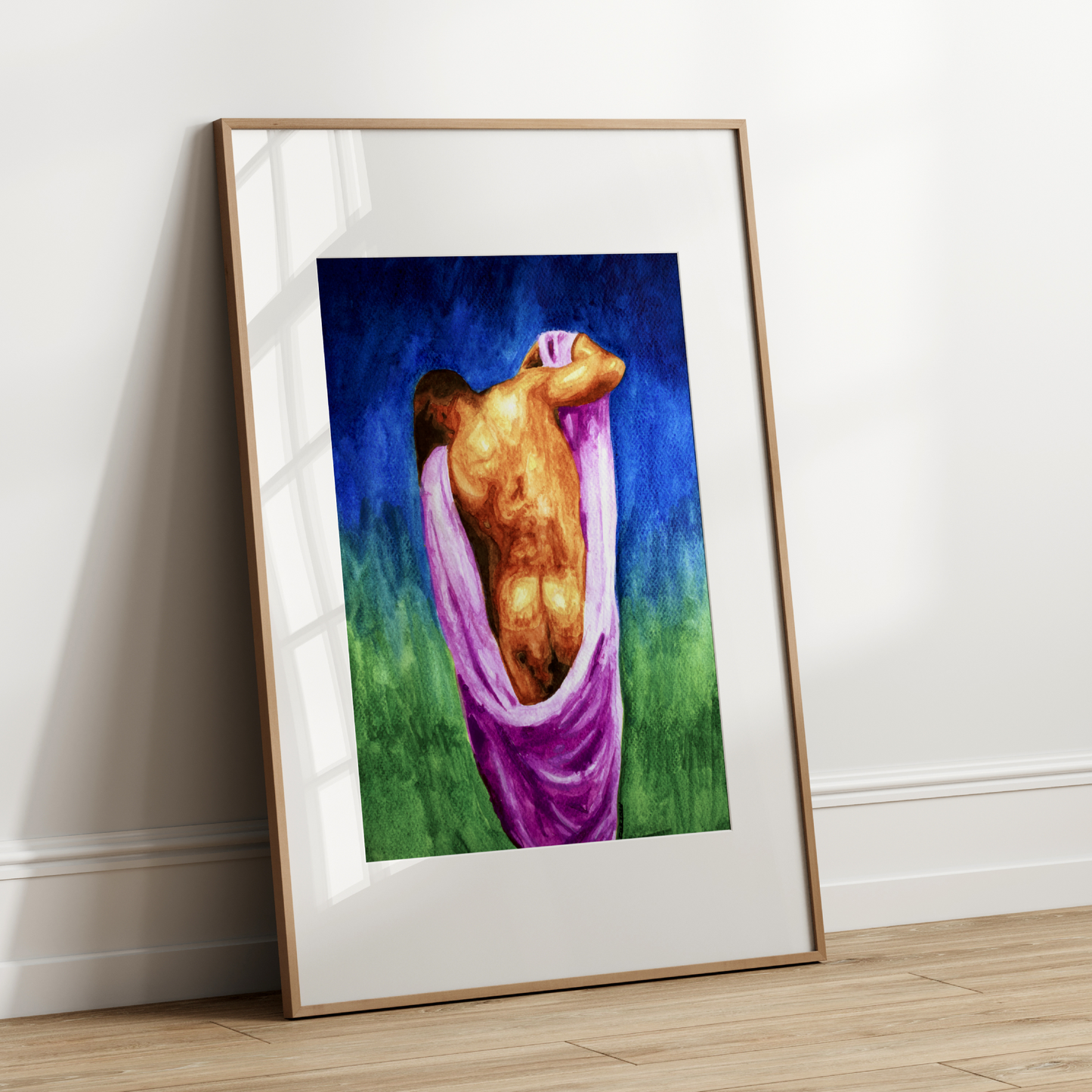 Framed artwork of a nude figure in a pink garment against a blue and green background, leaning against a white wall.