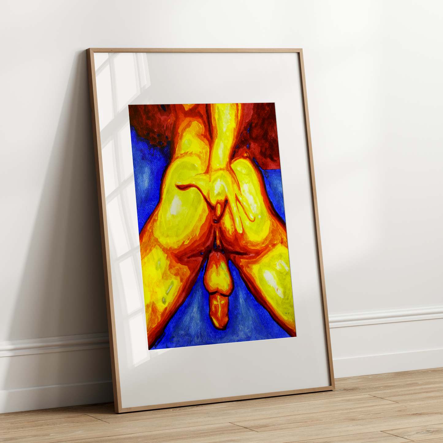 Framed artwork of a colorful abstract design on a white wall.