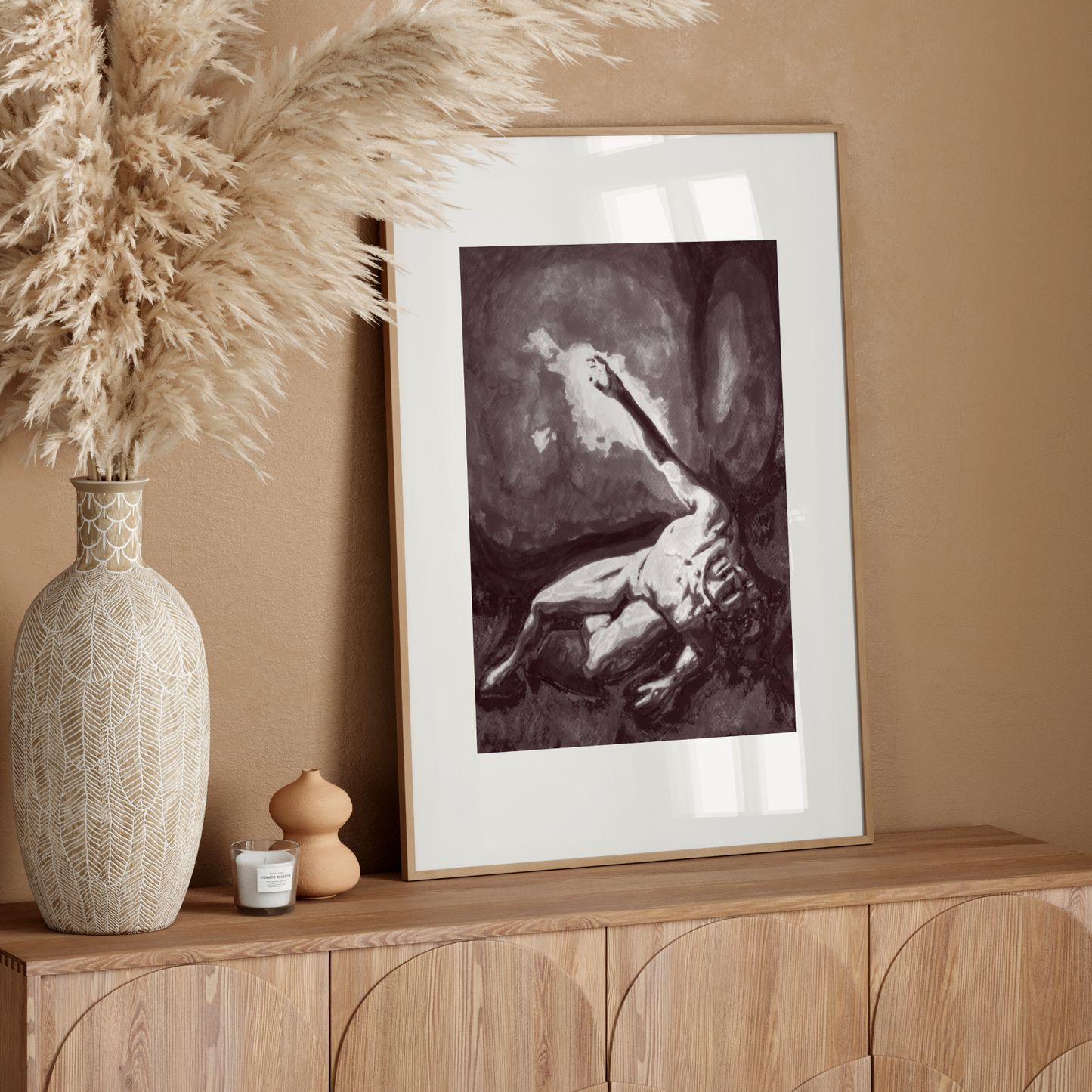 Framed artwork on a wooden sideboard with decorative elements against a beige wall.
