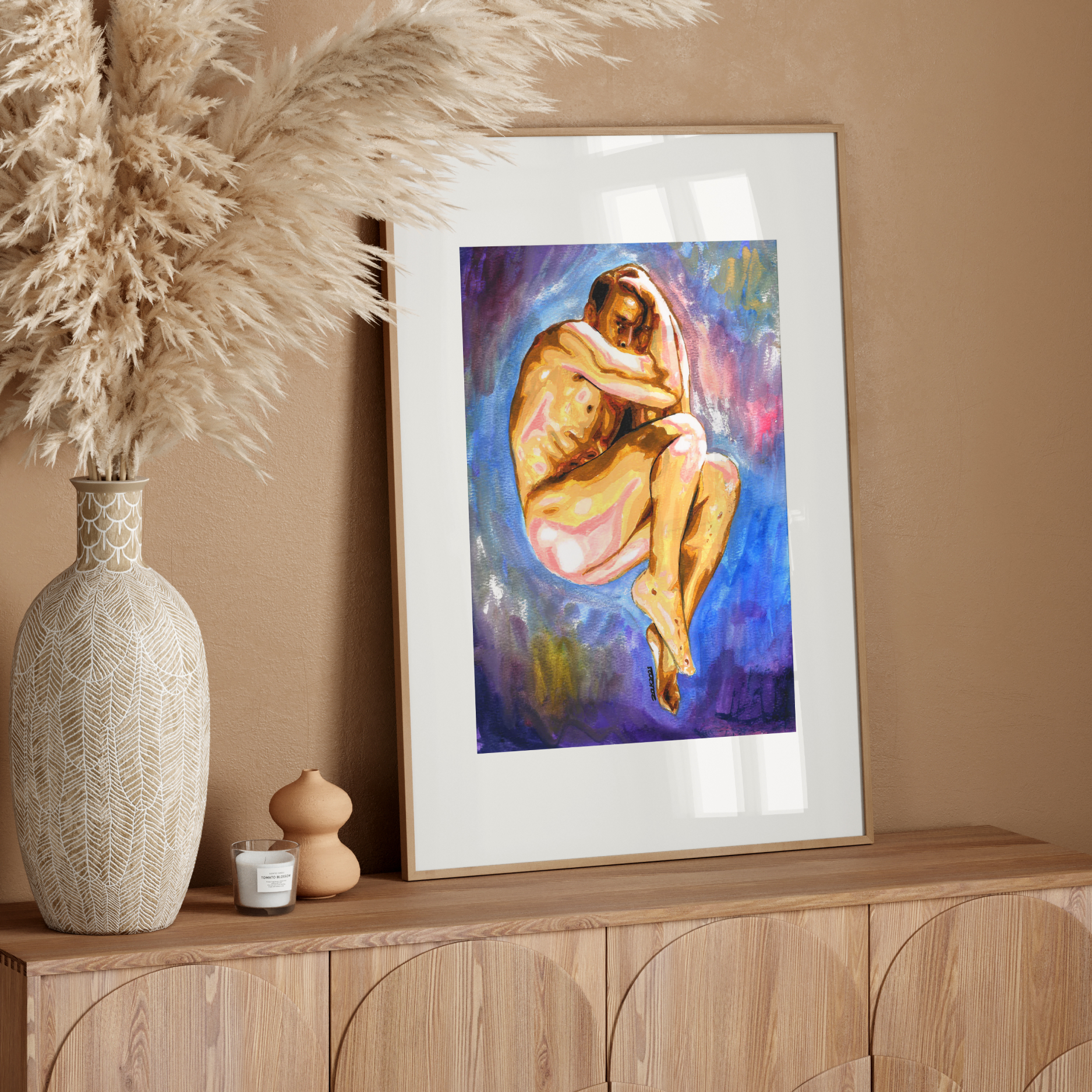 Framed artwork of a nude figure on a wooden sideboard with decorative elements.
