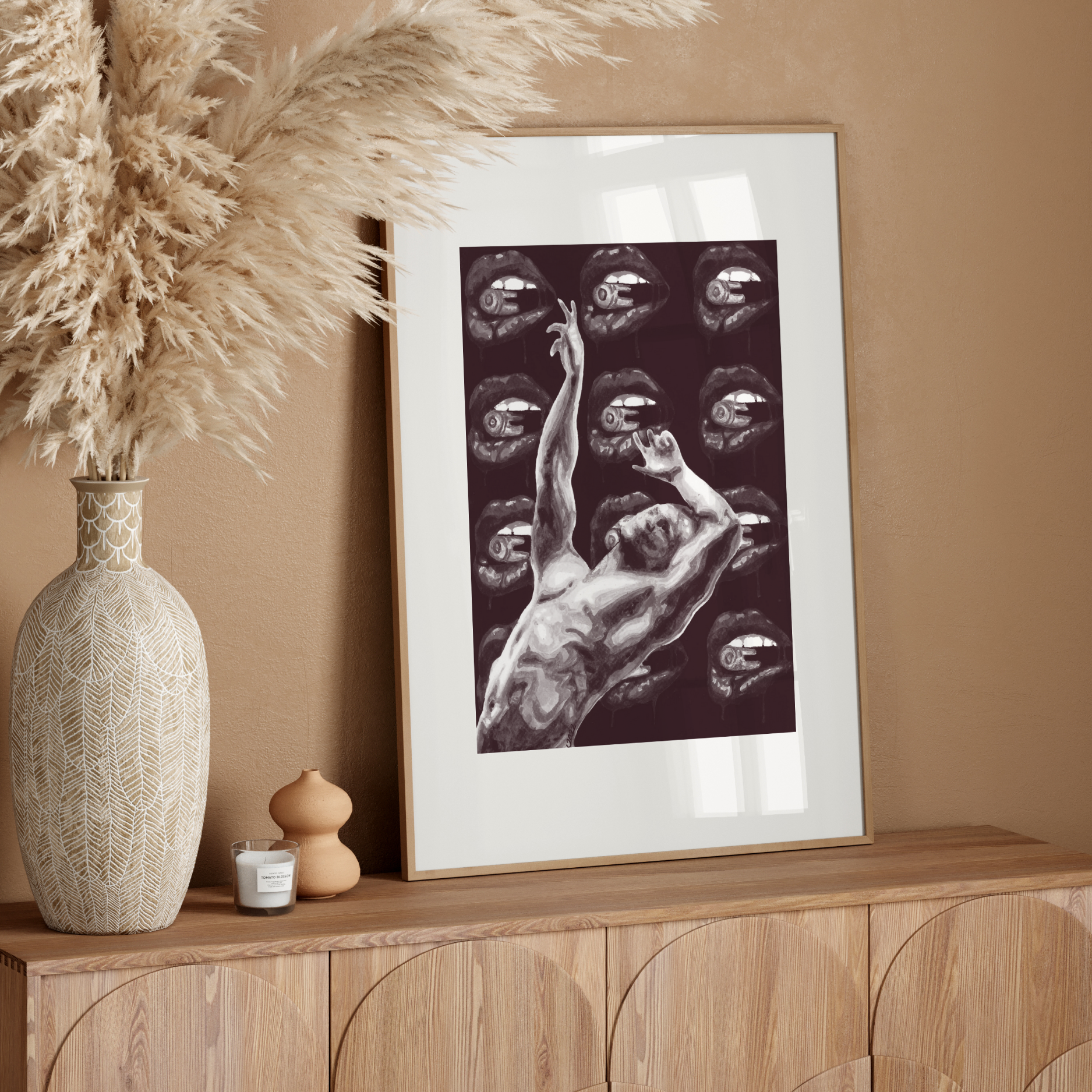 Framed artwork on a wooden console table with decorative elements against a beige wall.