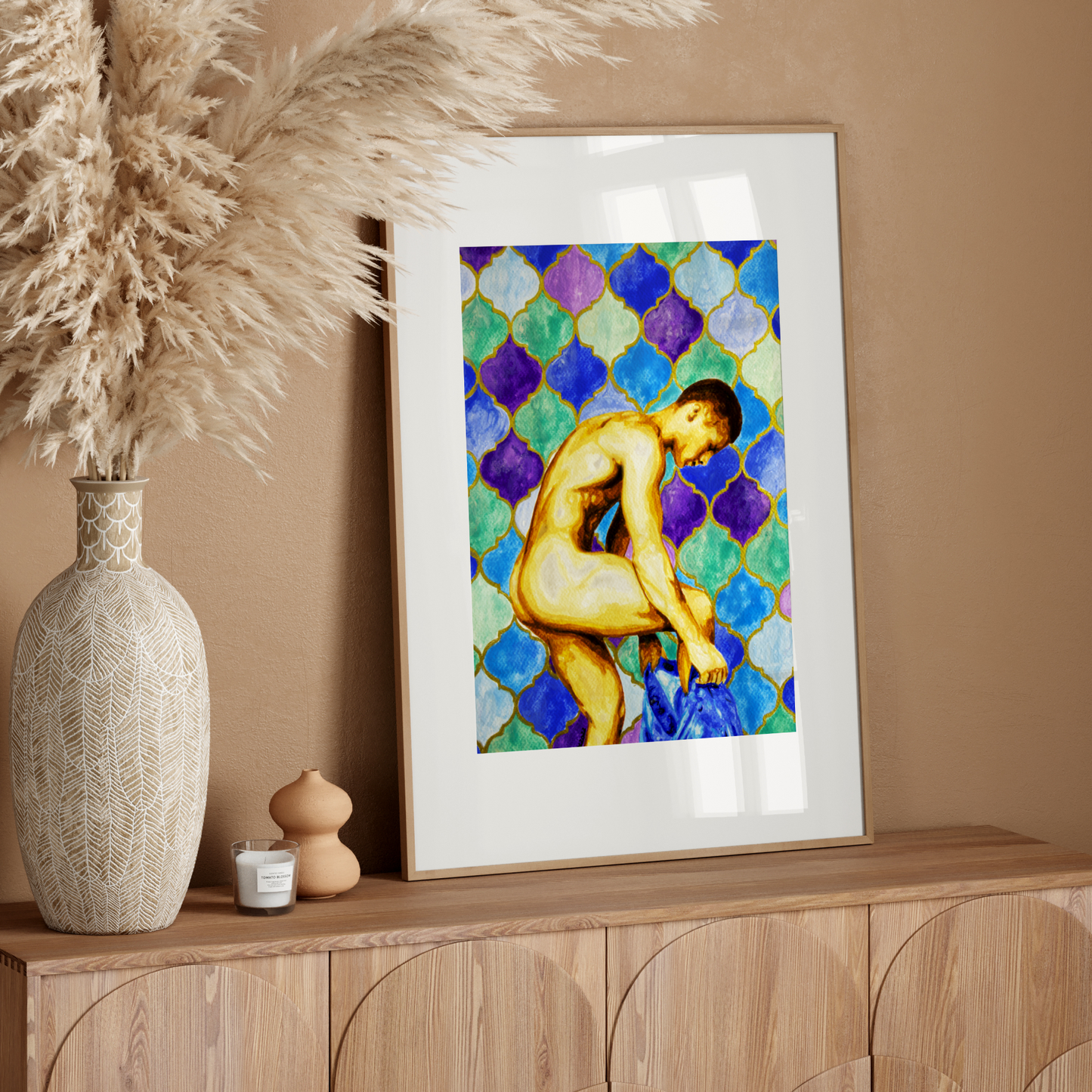 Framed artwork of a nude figure on a wooden sideboard with decorative elements.