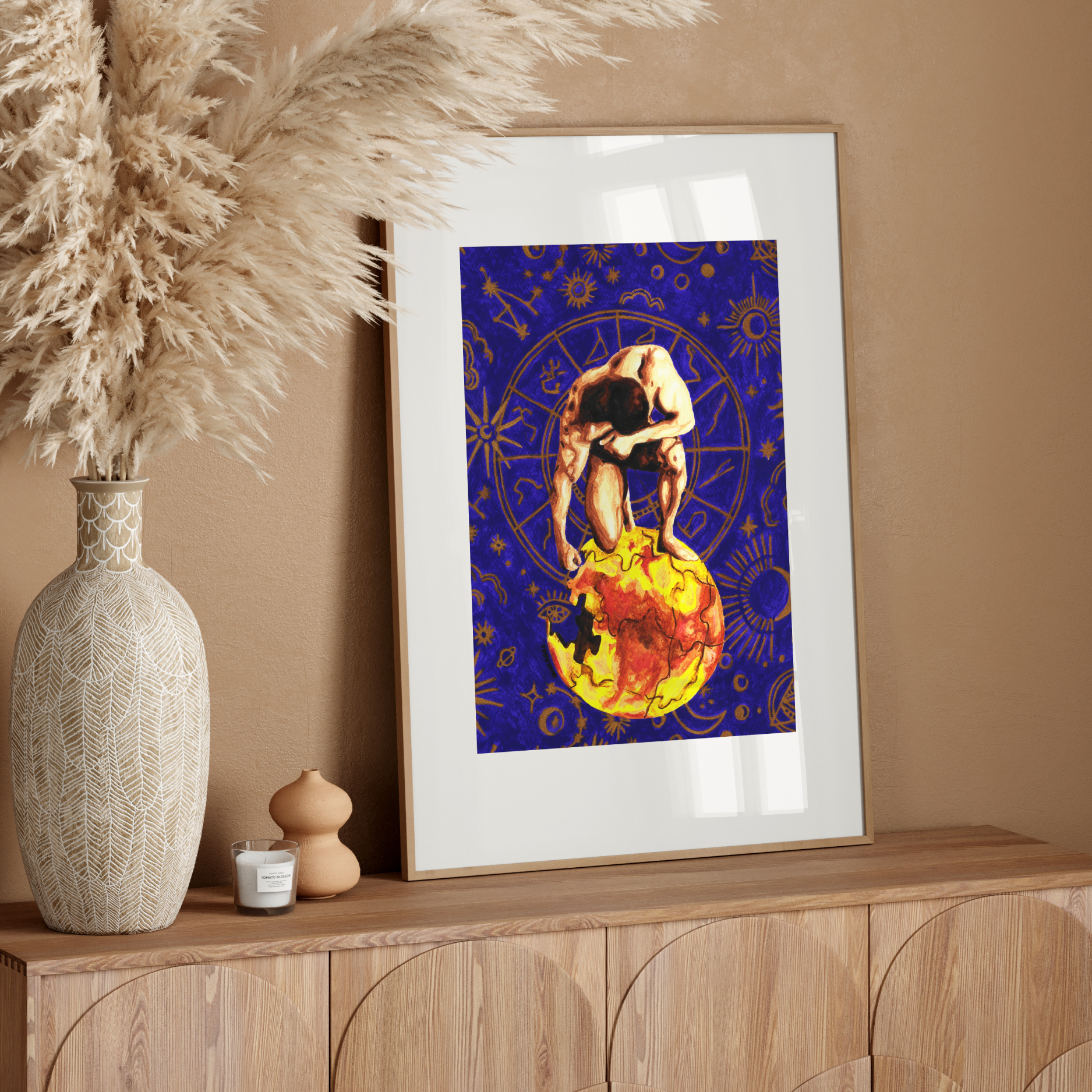 Framed artwork of a person embracing the Earth on a wooden sideboard with decorative elements.