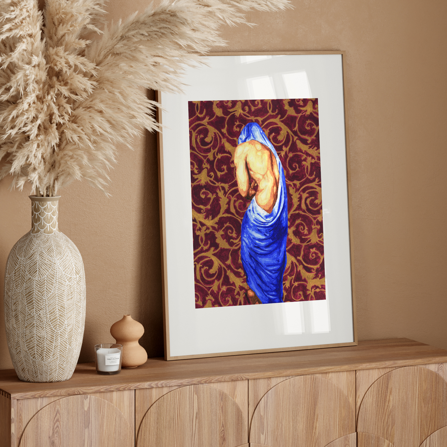 Framed artwork on a wooden console table with decorative elements.