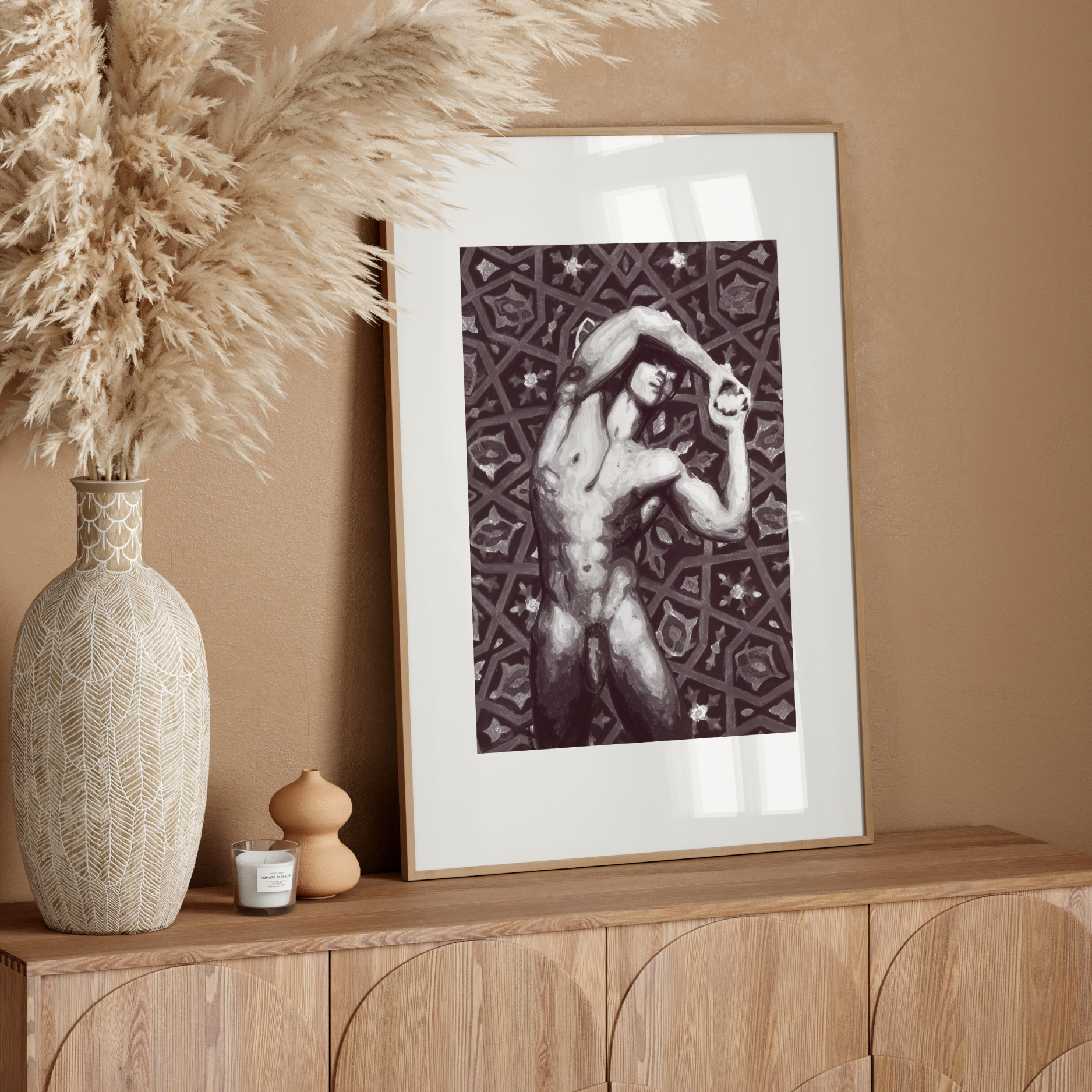 Framed artwork on a wooden console table with decorative elements against a beige wall.