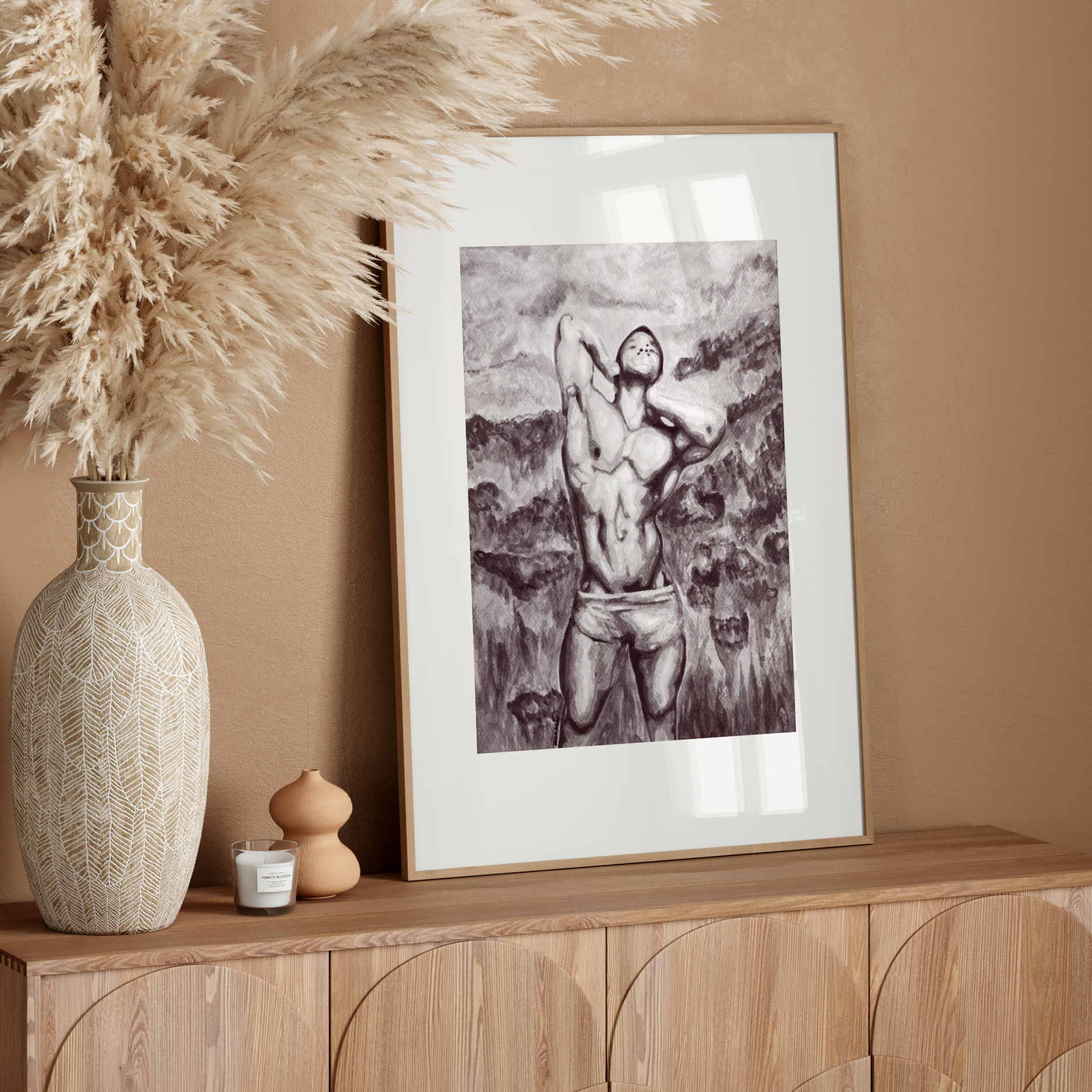 Framed artwork on a wooden console table with decorative elements against a beige wall.