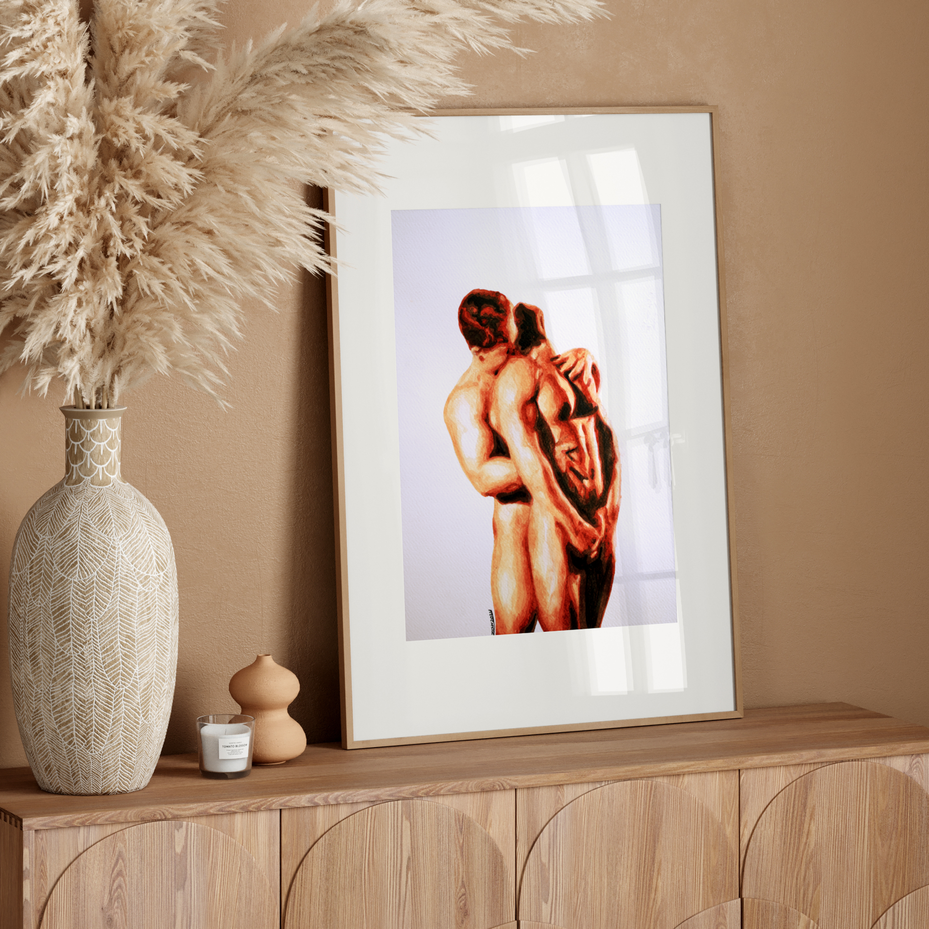 Framed artwork of a couple embracing on a wooden sideboard with decorative elements.