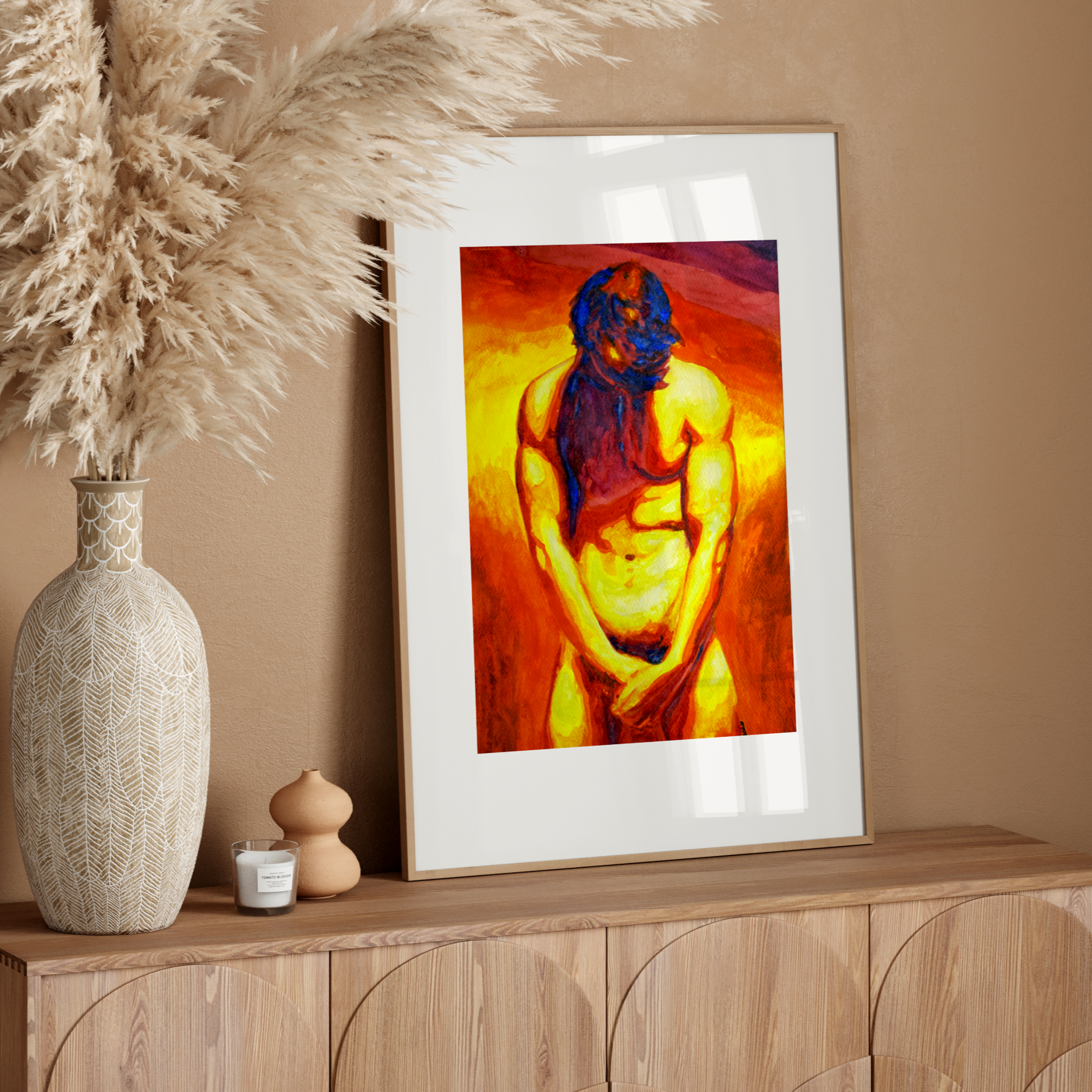 Framed artwork of a nude figure on a wooden sideboard with decorative elements.