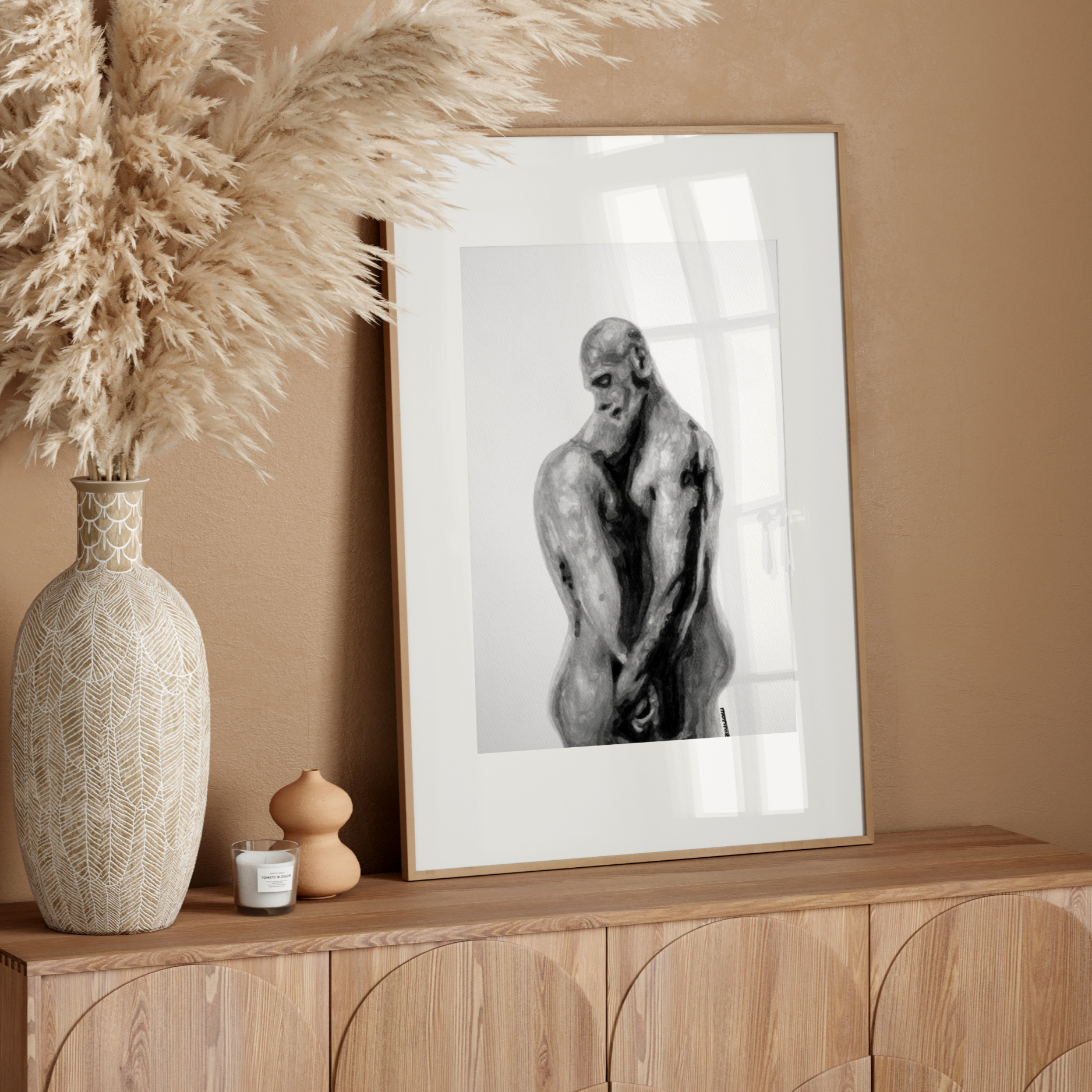 Framed artwork of a monkey on a wooden sideboard with decorative elements against a beige wall.