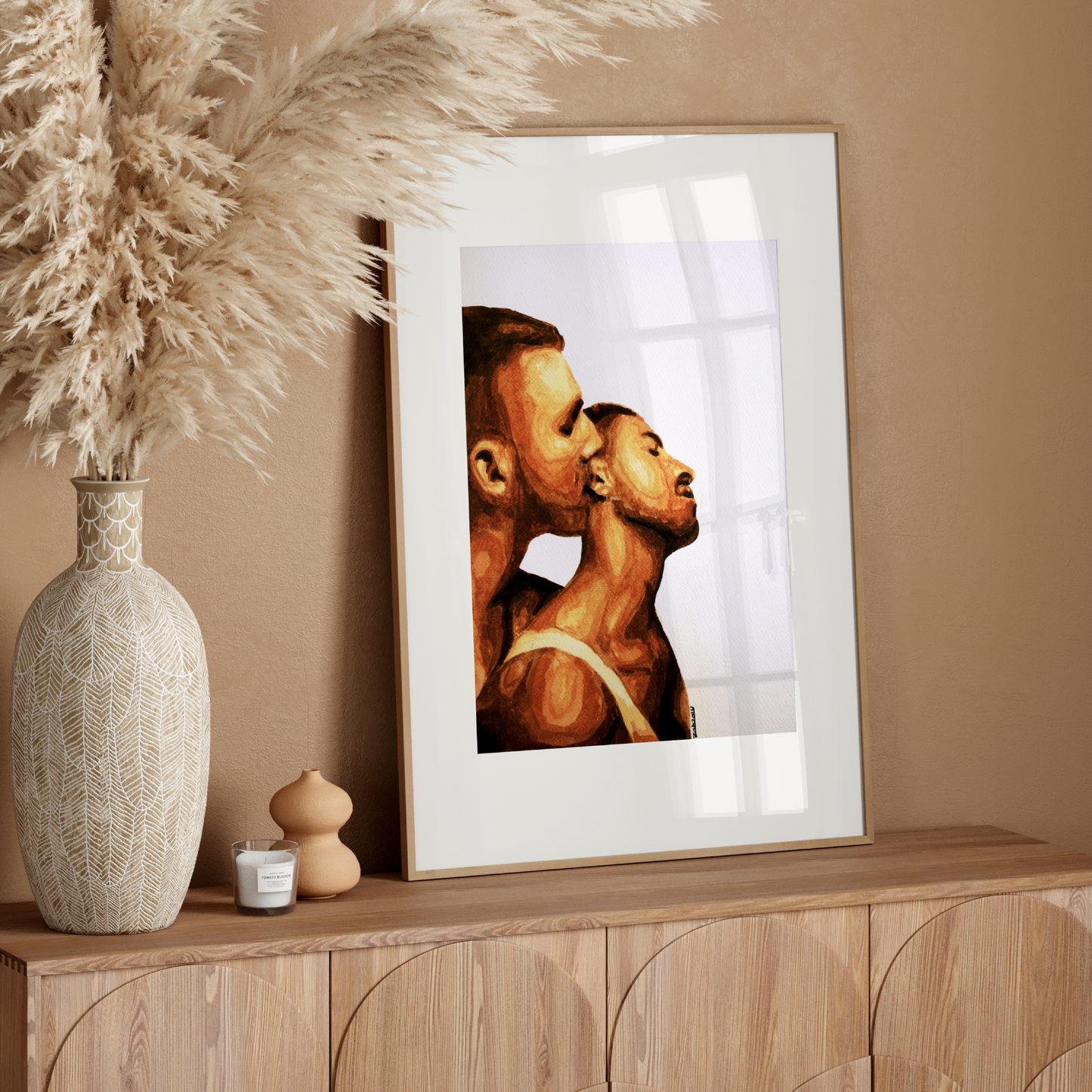 Framed artwork of two profiles on a white wall