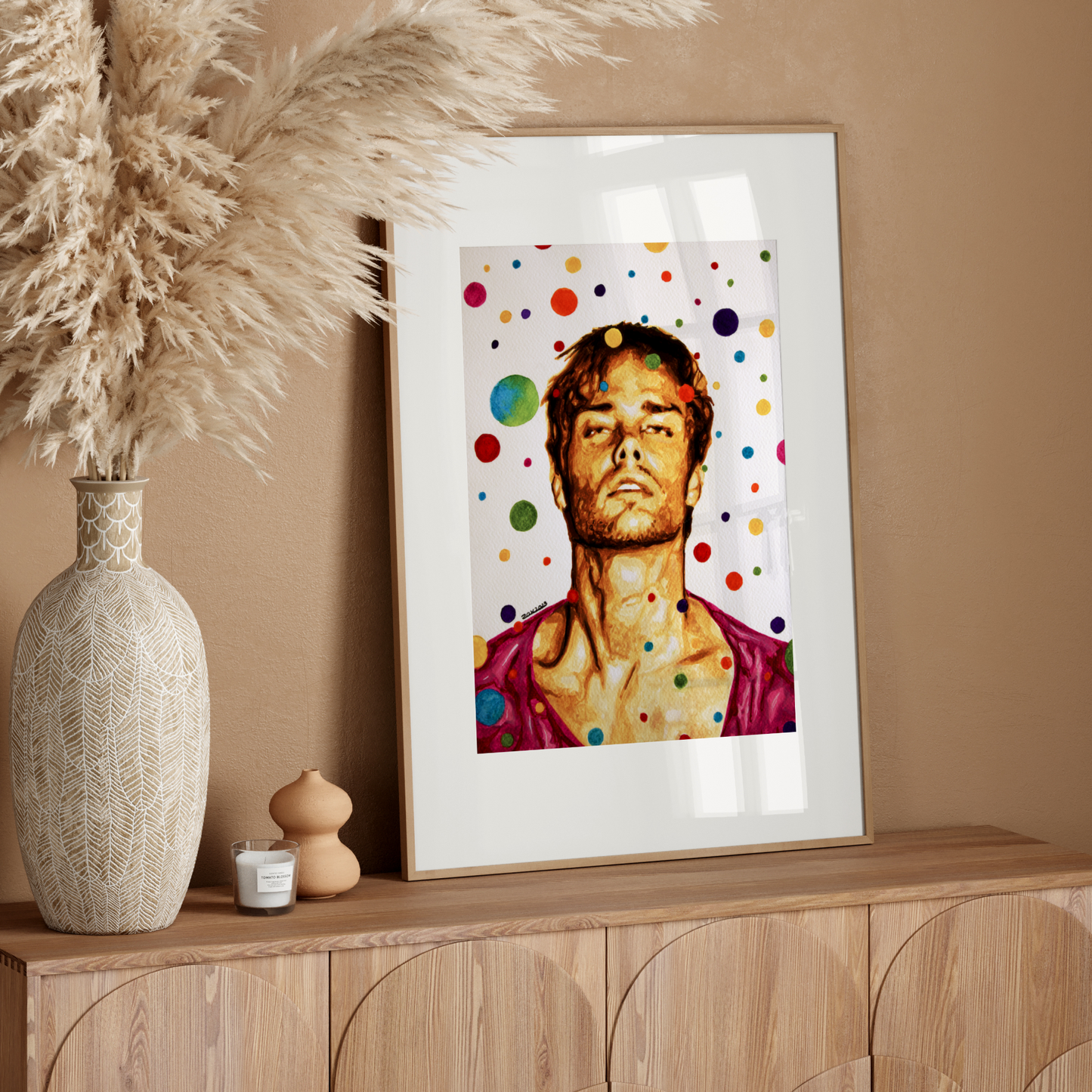 Framed artwork on a wooden sideboard with decorative elements.