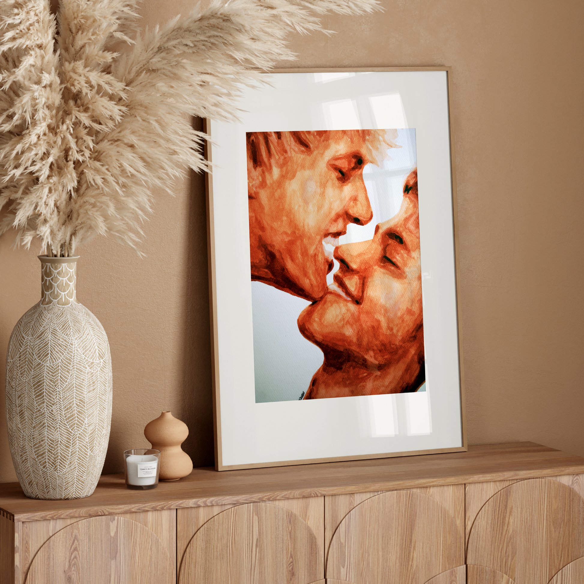 Framed artwork of two faces on a wooden sideboard with decorative elements.
