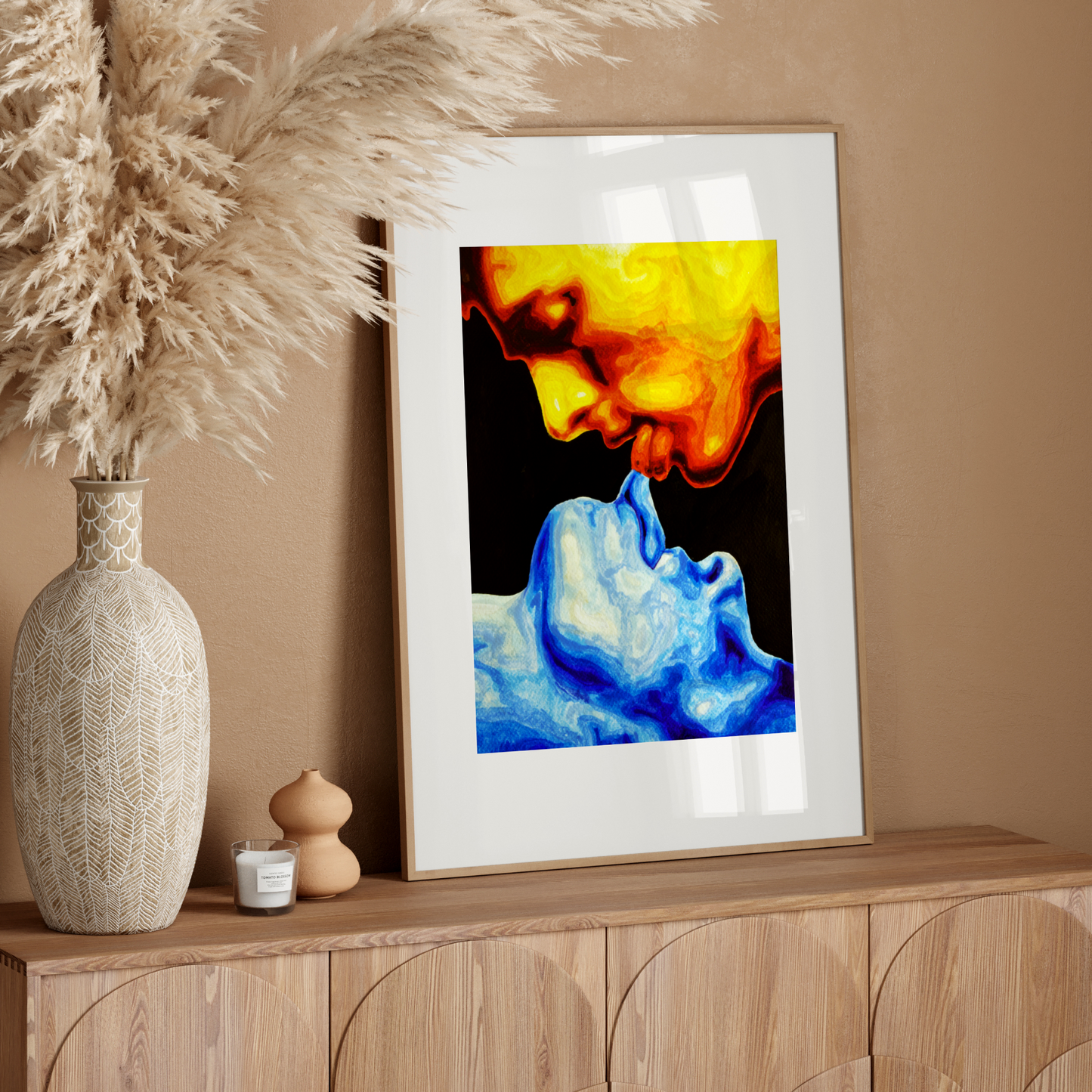 Framed abstract art on a wooden sideboard with decorative elements.