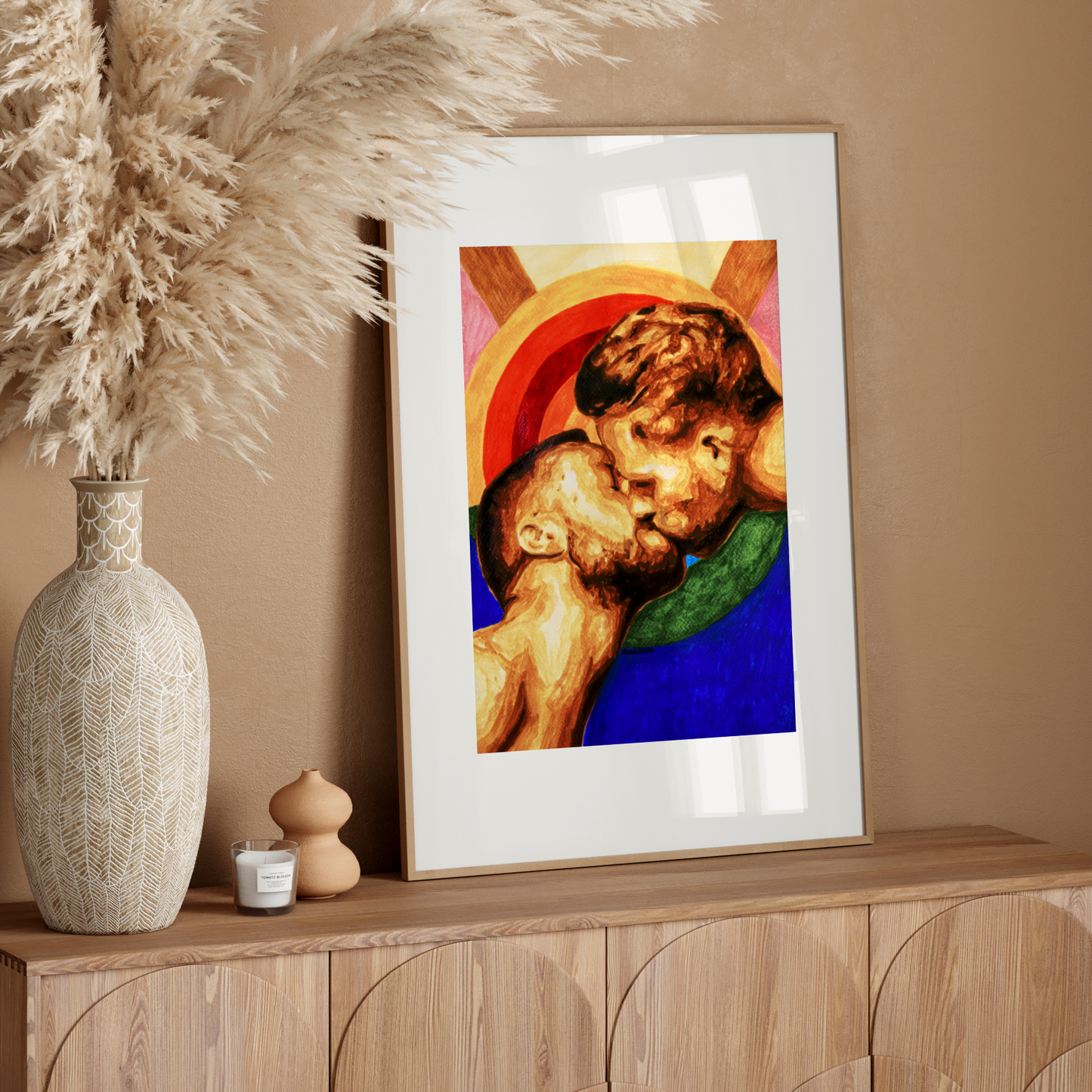 Framed artwork of two children embracing on a  wall.