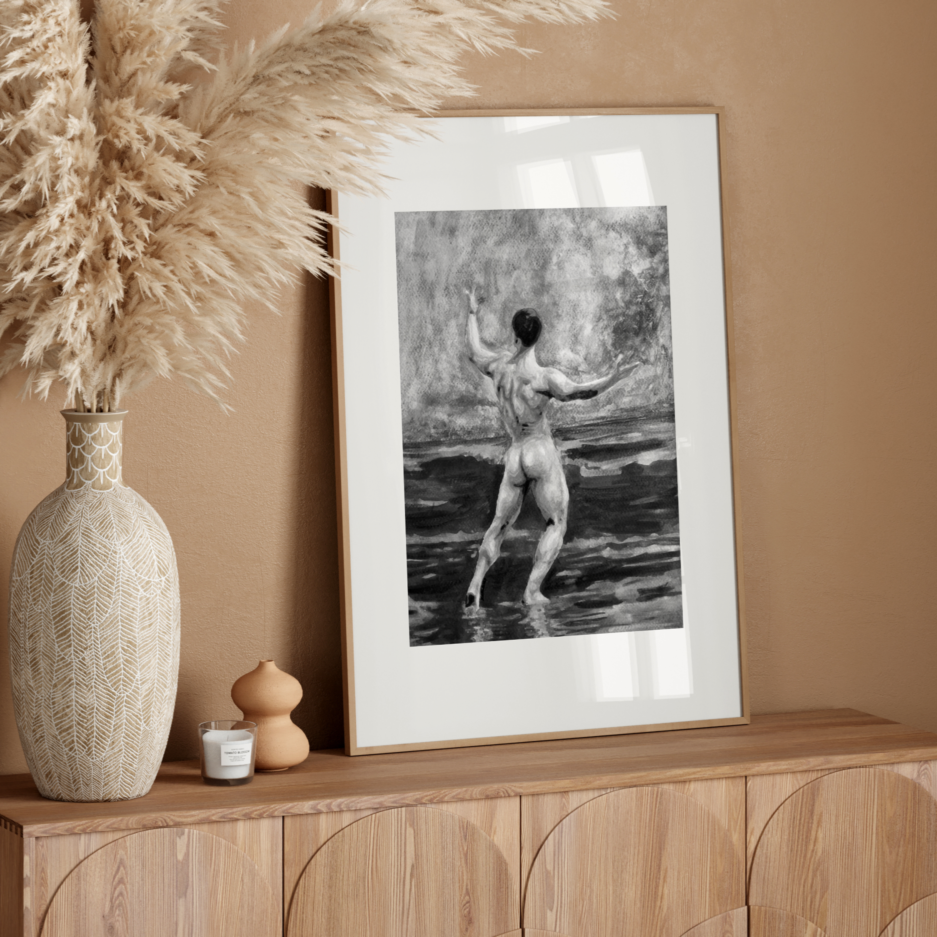 Framed artwork of a nude figure on a wooden sideboard with decorative elements.
