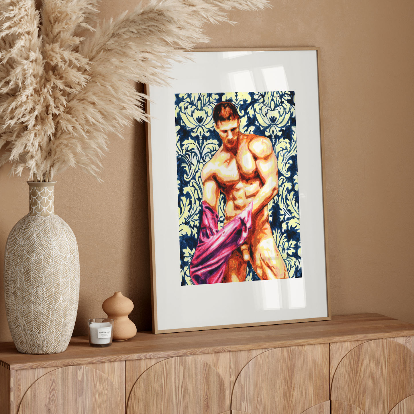Framed artwork of a muscular figure on a wooden sideboard with decorative elements.