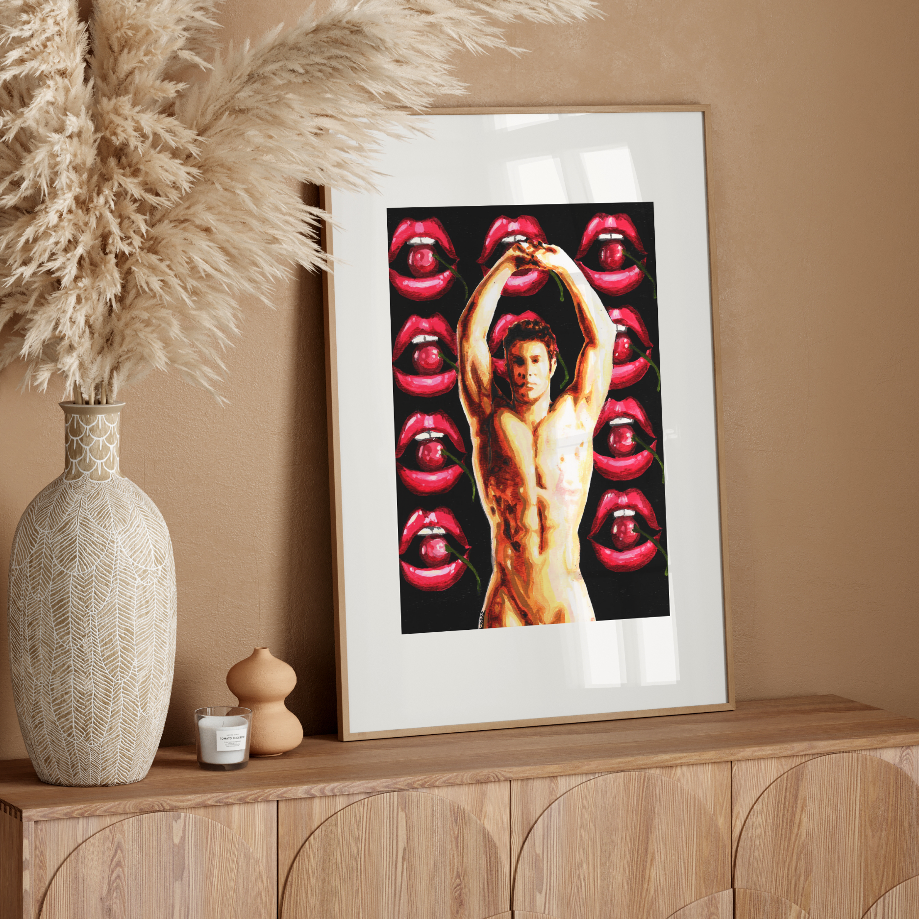 Framed artwork of a man with red lips on a wooden sideboard against a beige wall.