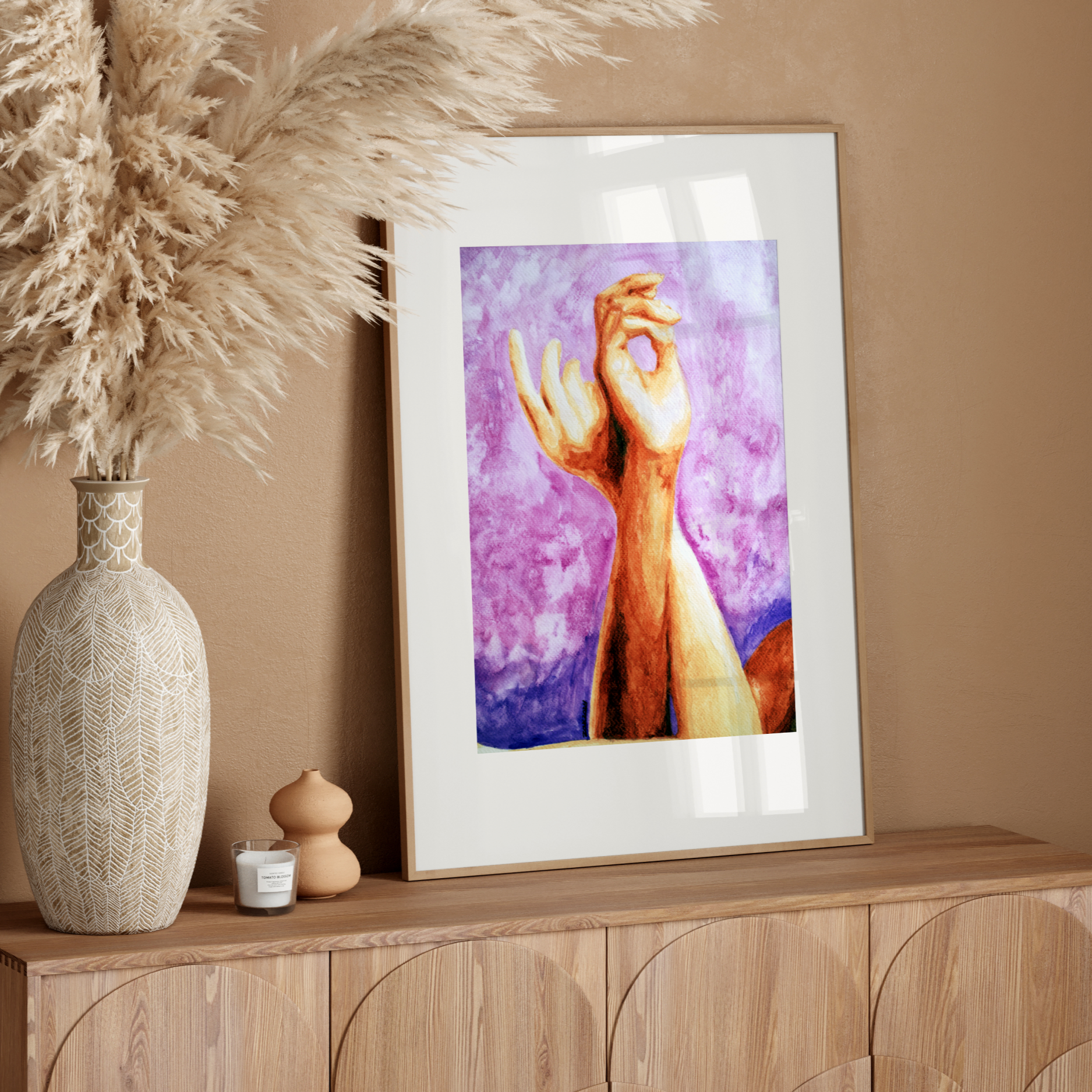 Framed artwork on a wooden console table with decorative elements.
