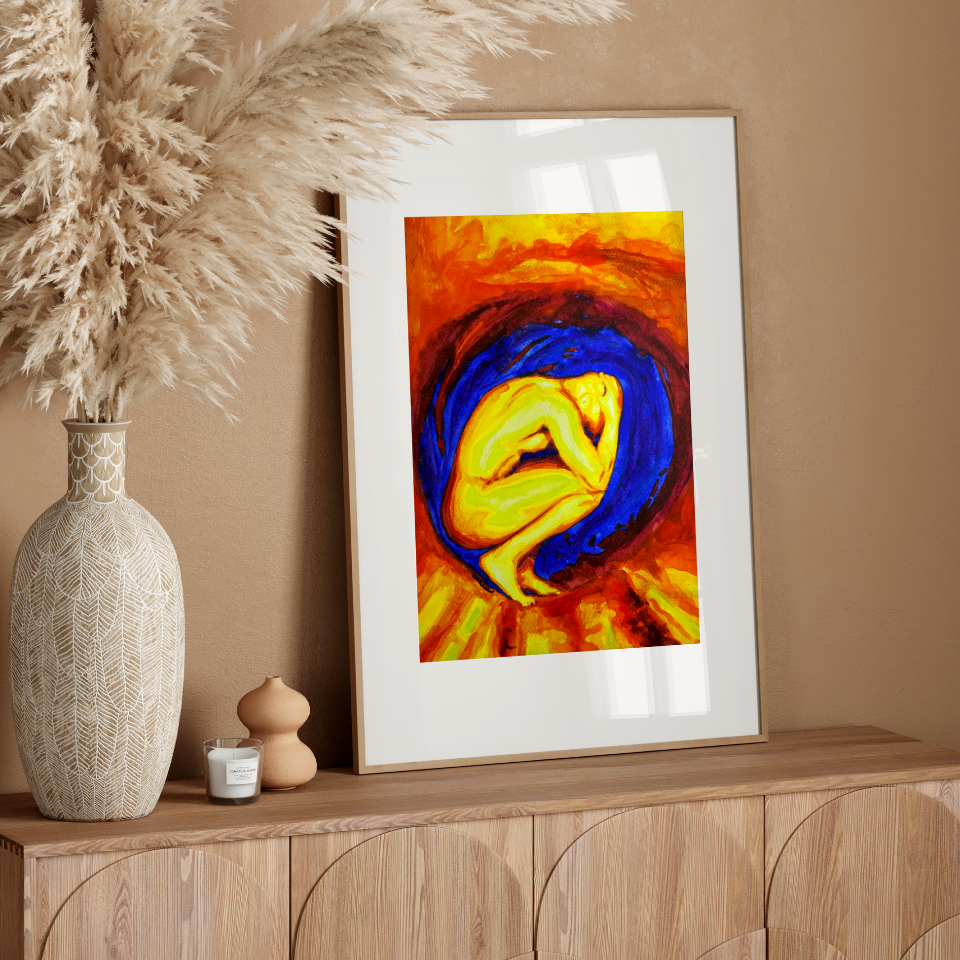 Framed abstract art on a wooden console table with decorative elements.