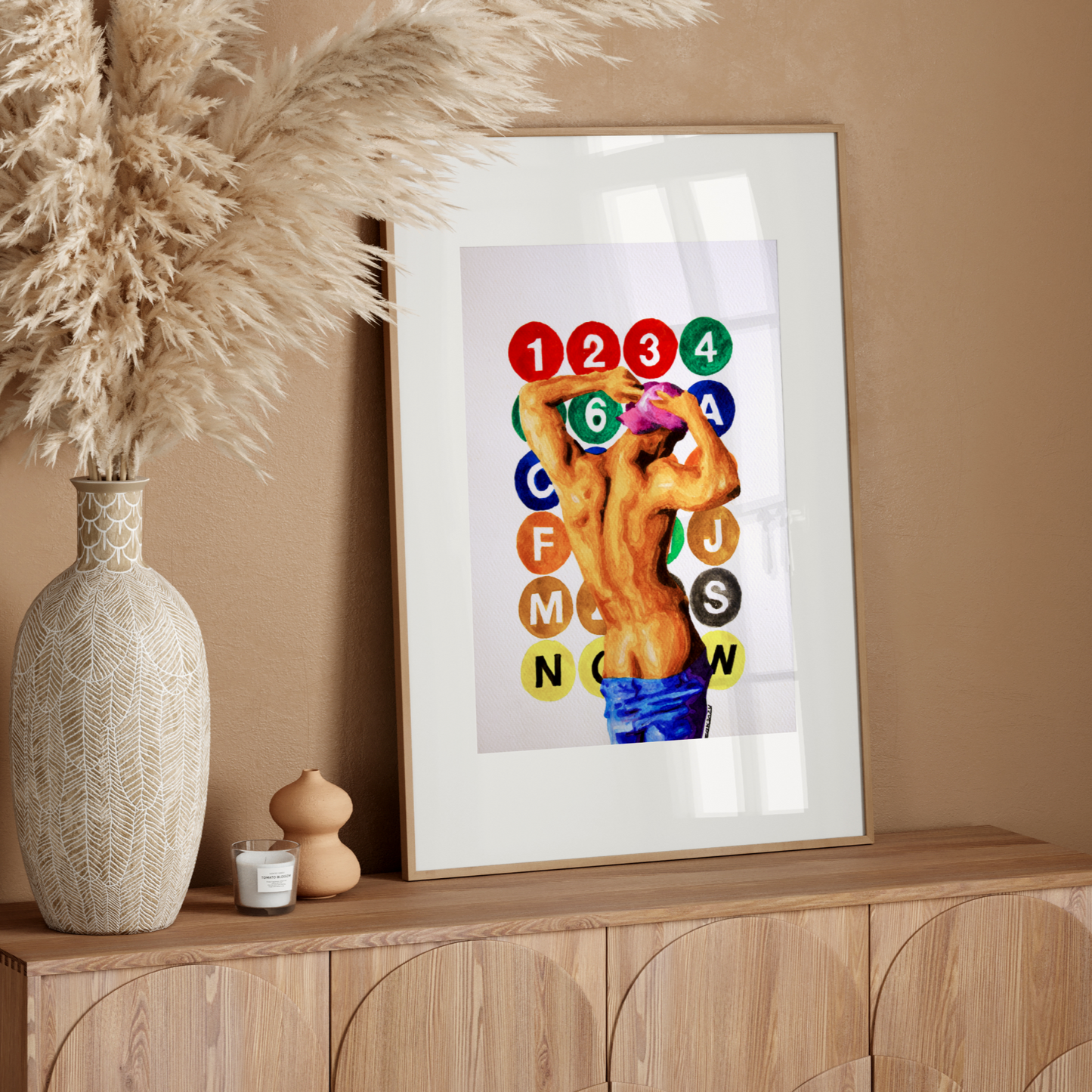 Framed colorful artwork on a wooden sideboard with decorative elements.