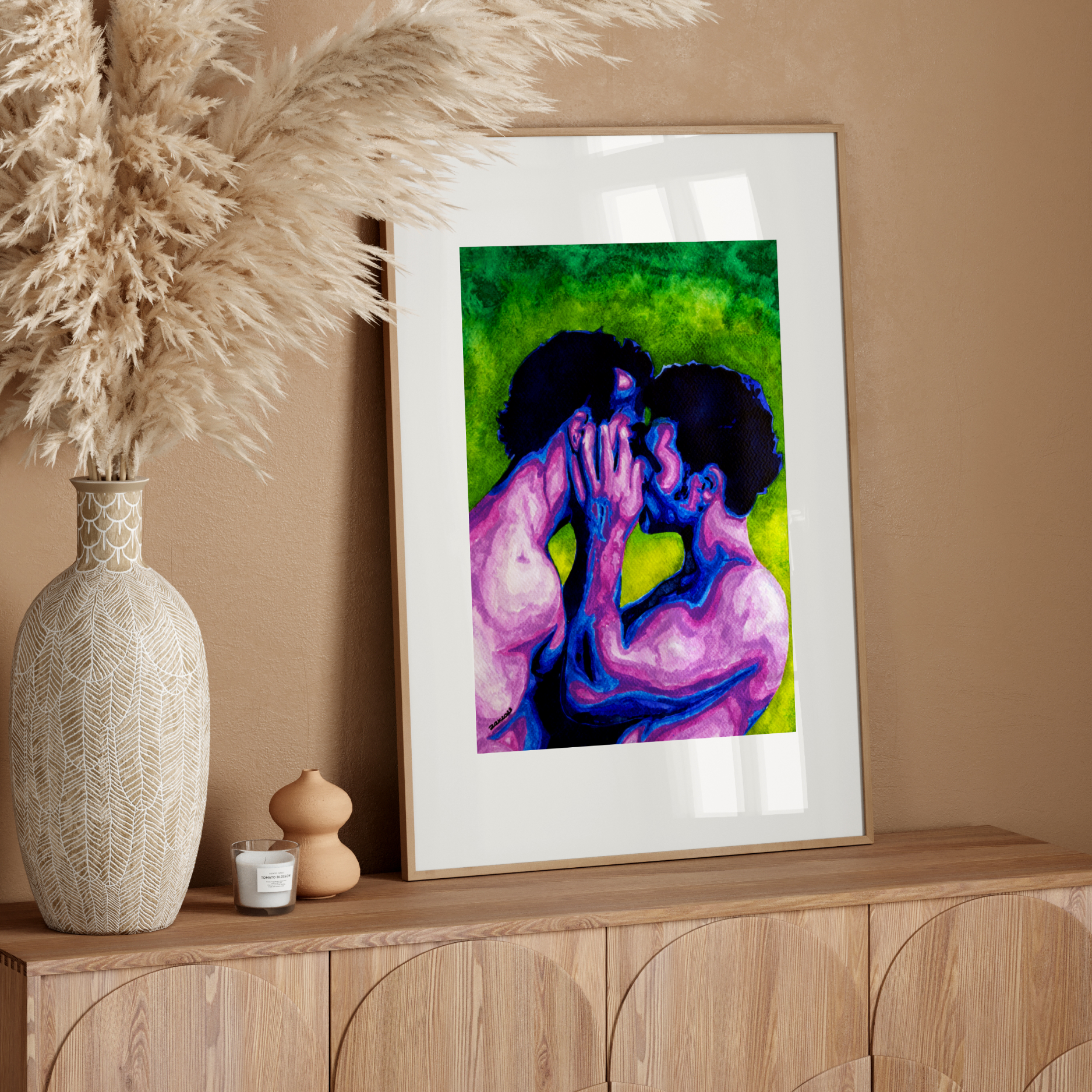 Framed artwork of two people embracing on a wooden sideboard with decorative elements.