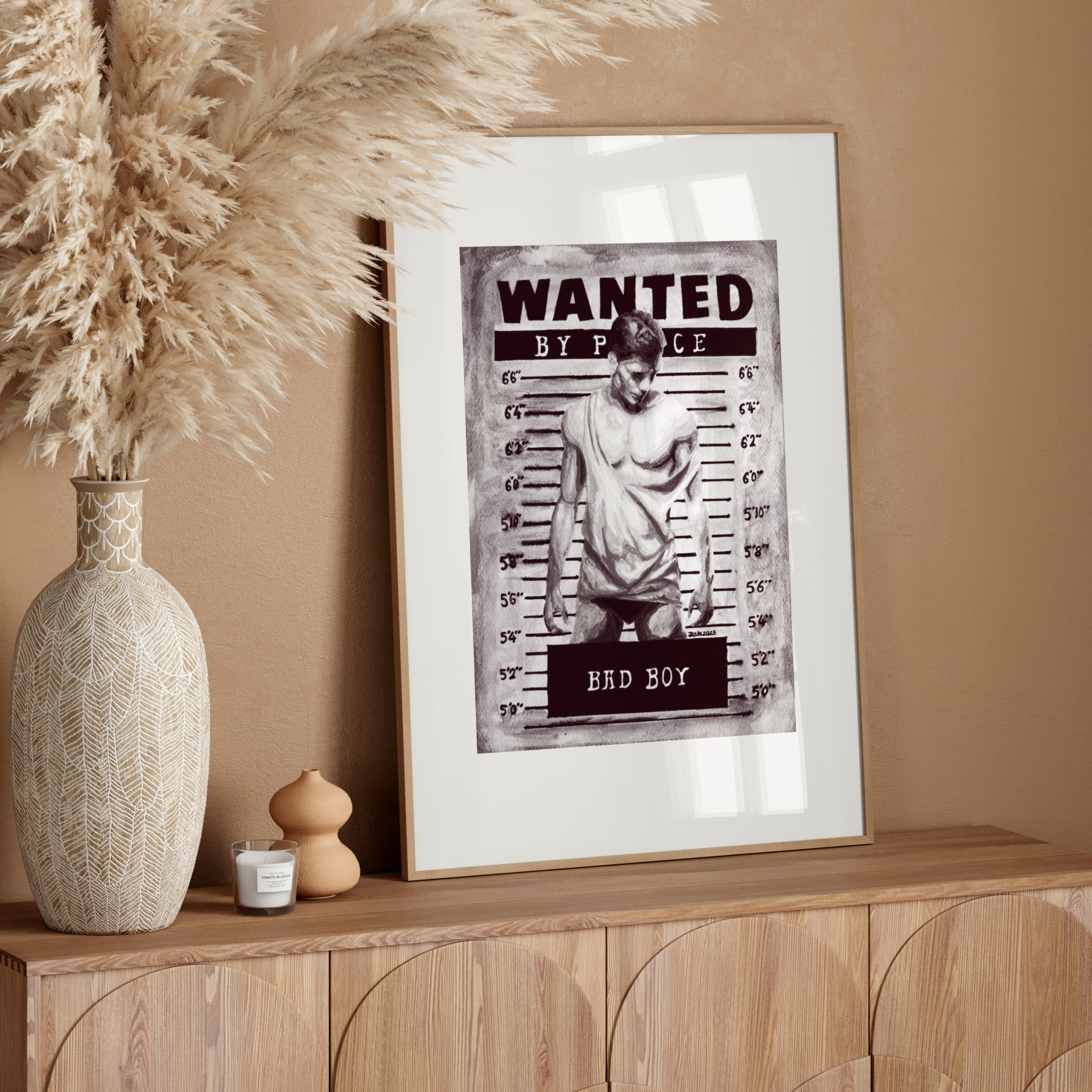 Framed 'Wanted' poster on a wooden sideboard with decorative elements.