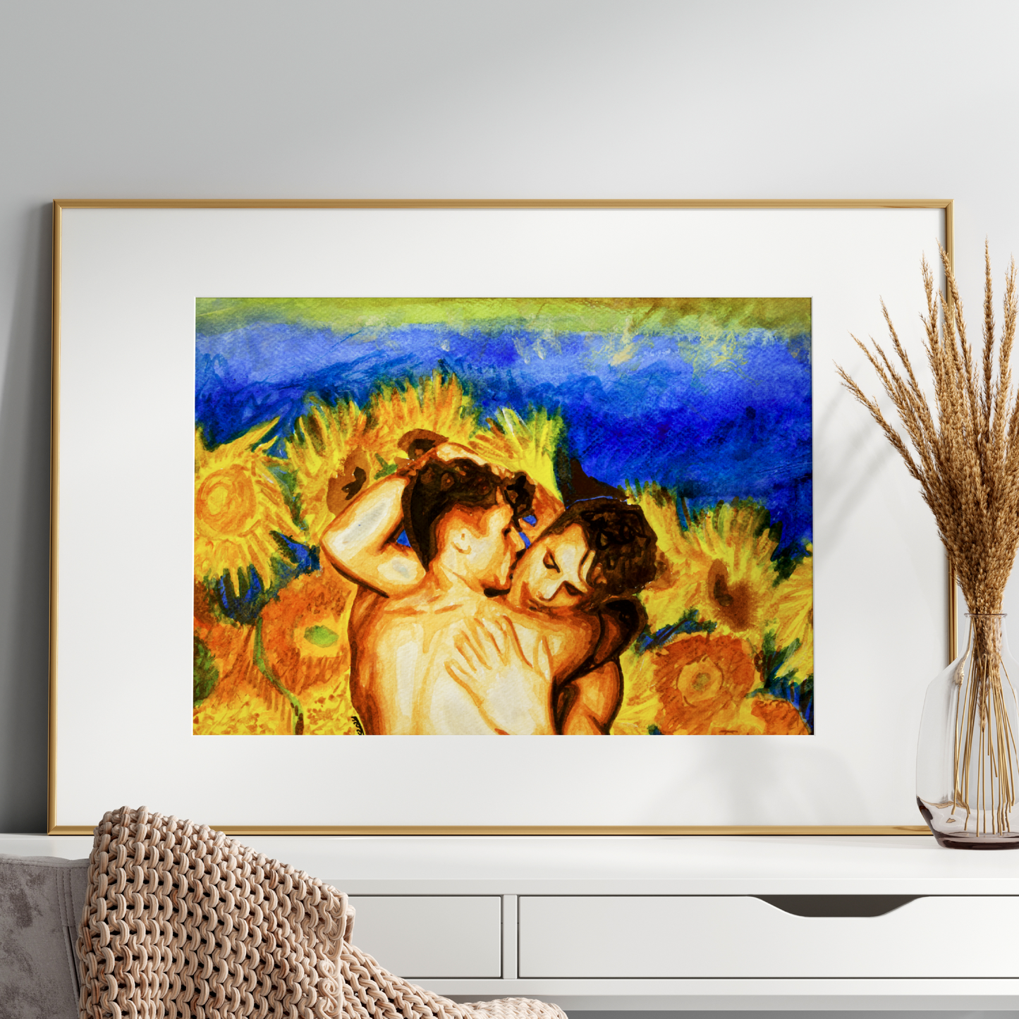 Framed artwork of two people embracing with sunflowers on a white wall.