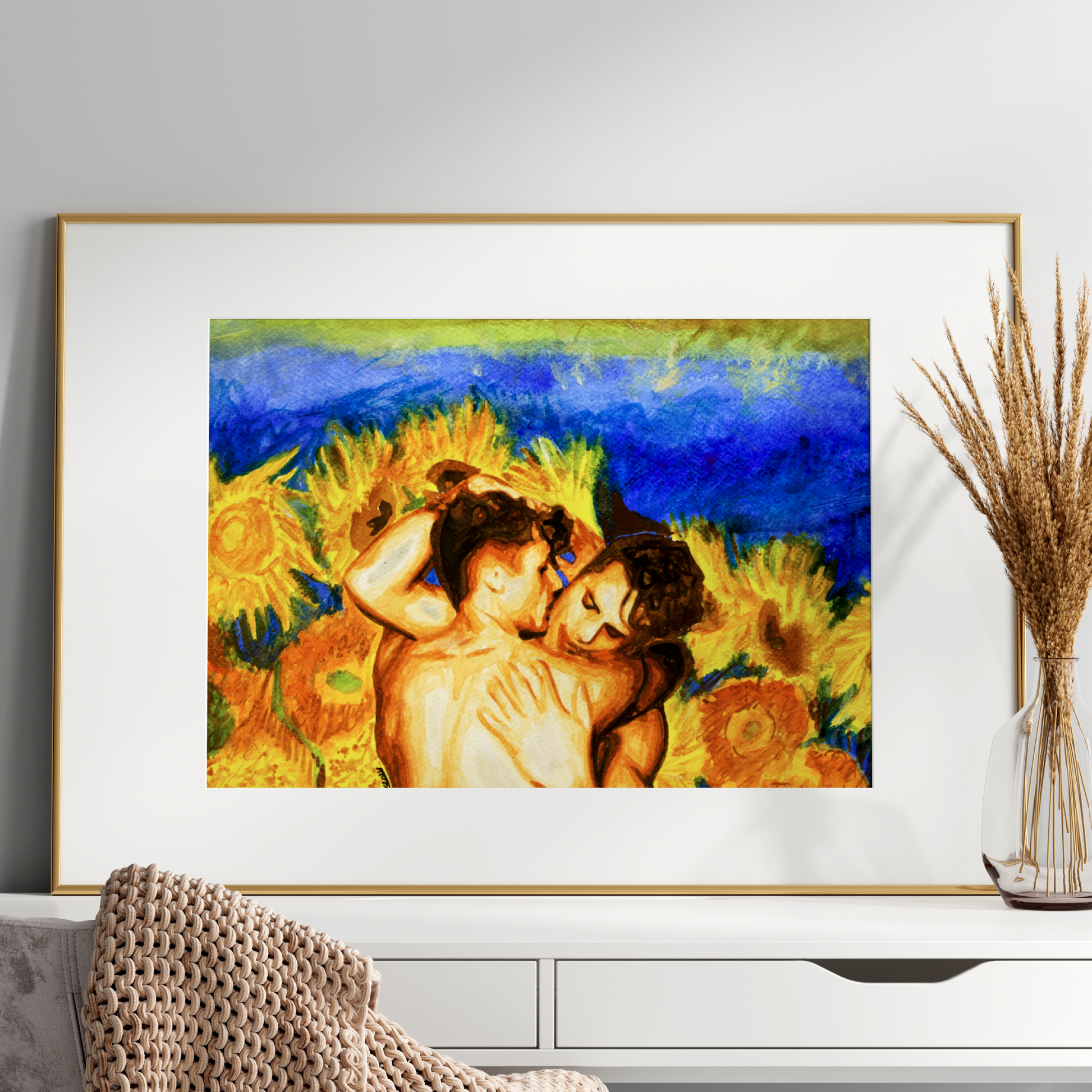 Framed artwork of two people embracing with sunflowers on a white wall.