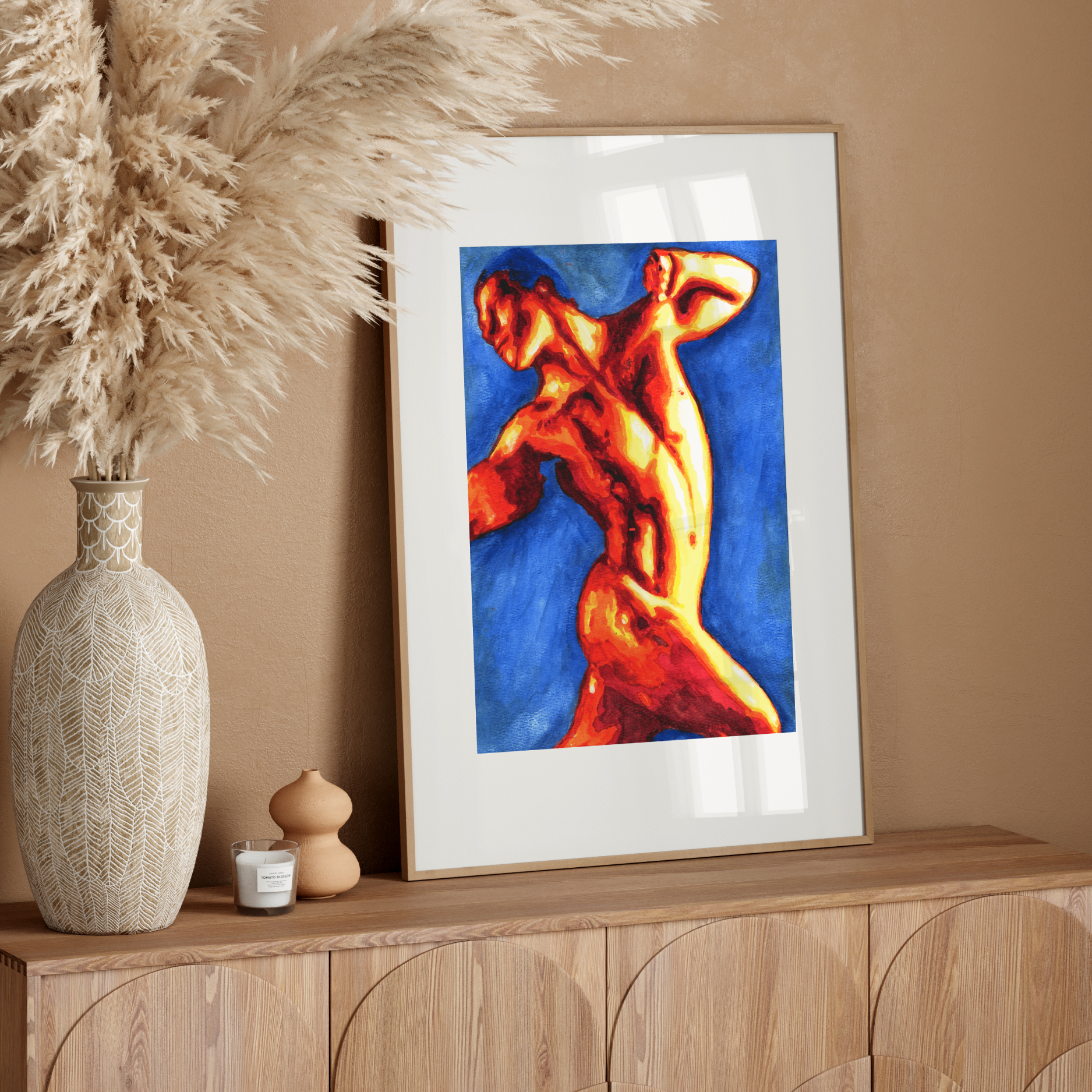 Framed abstract artwork of a nude figure on a wooden sideboard with decorative elements.