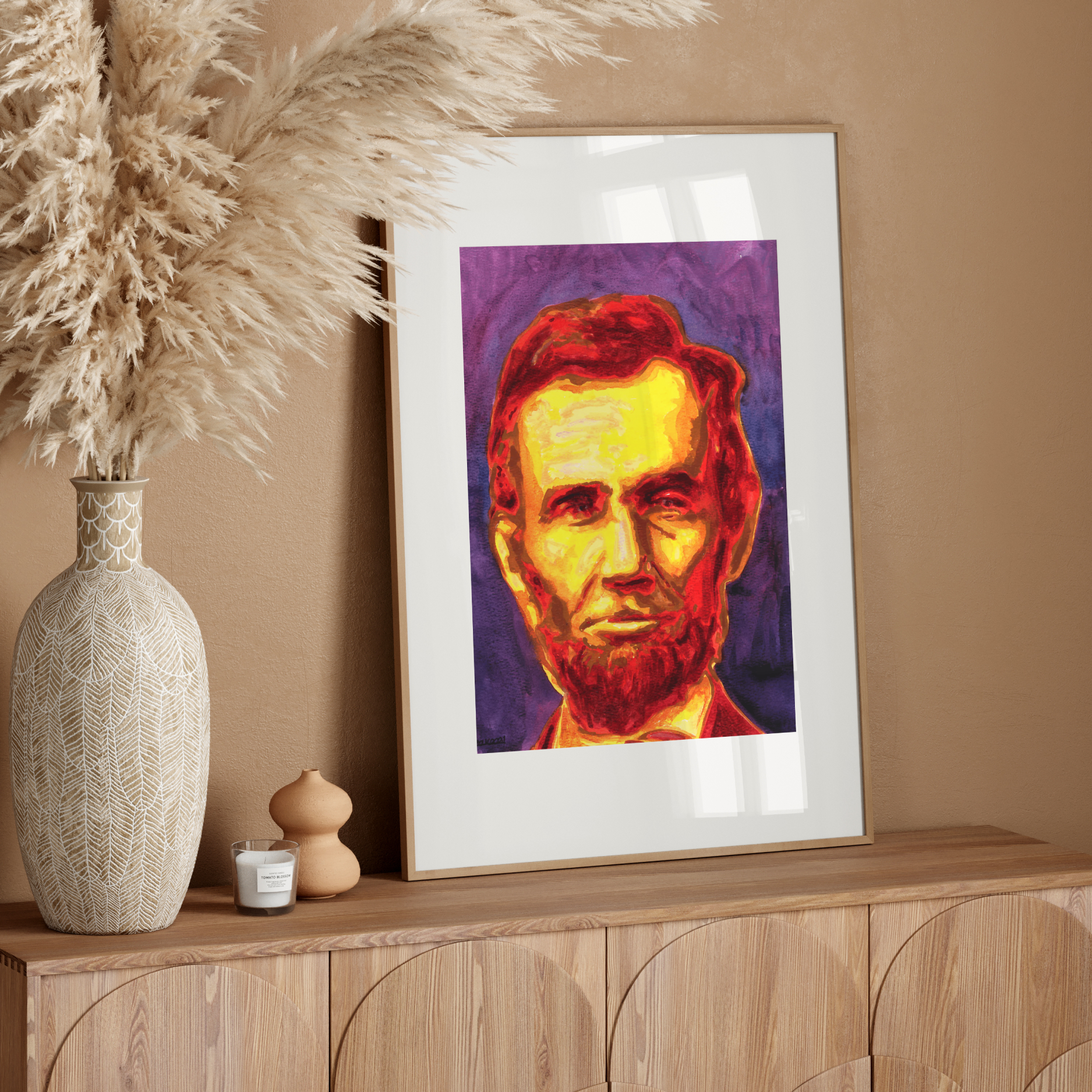 Framed portrait of a historical figure on a wooden sideboard with decorative elements.