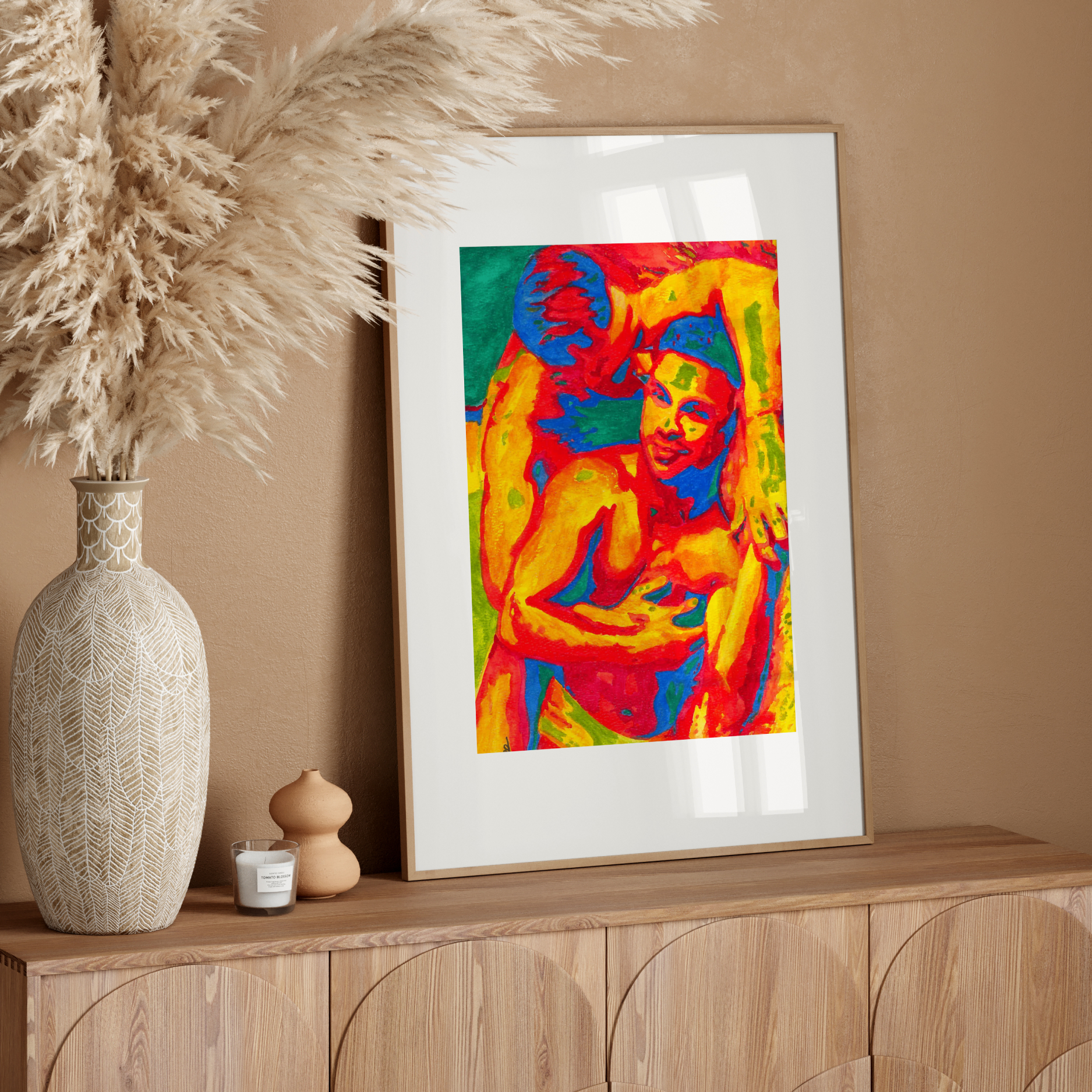 Framed colorful artwork of gay couple kissing on a white wall
