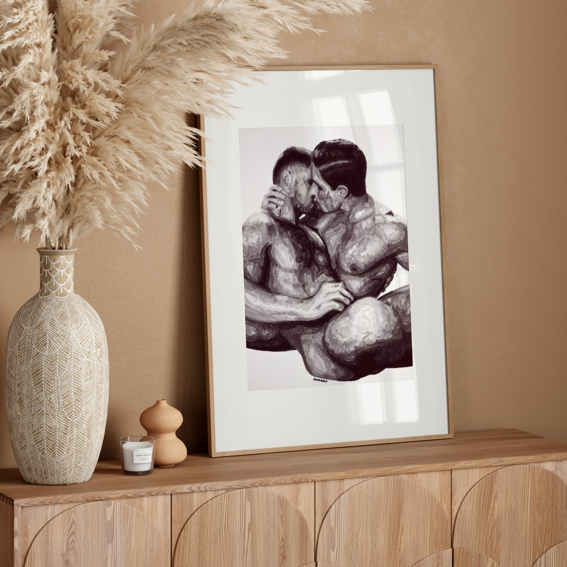 Framed artwork of two people embracing on a wooden sideboard with decorative elements.