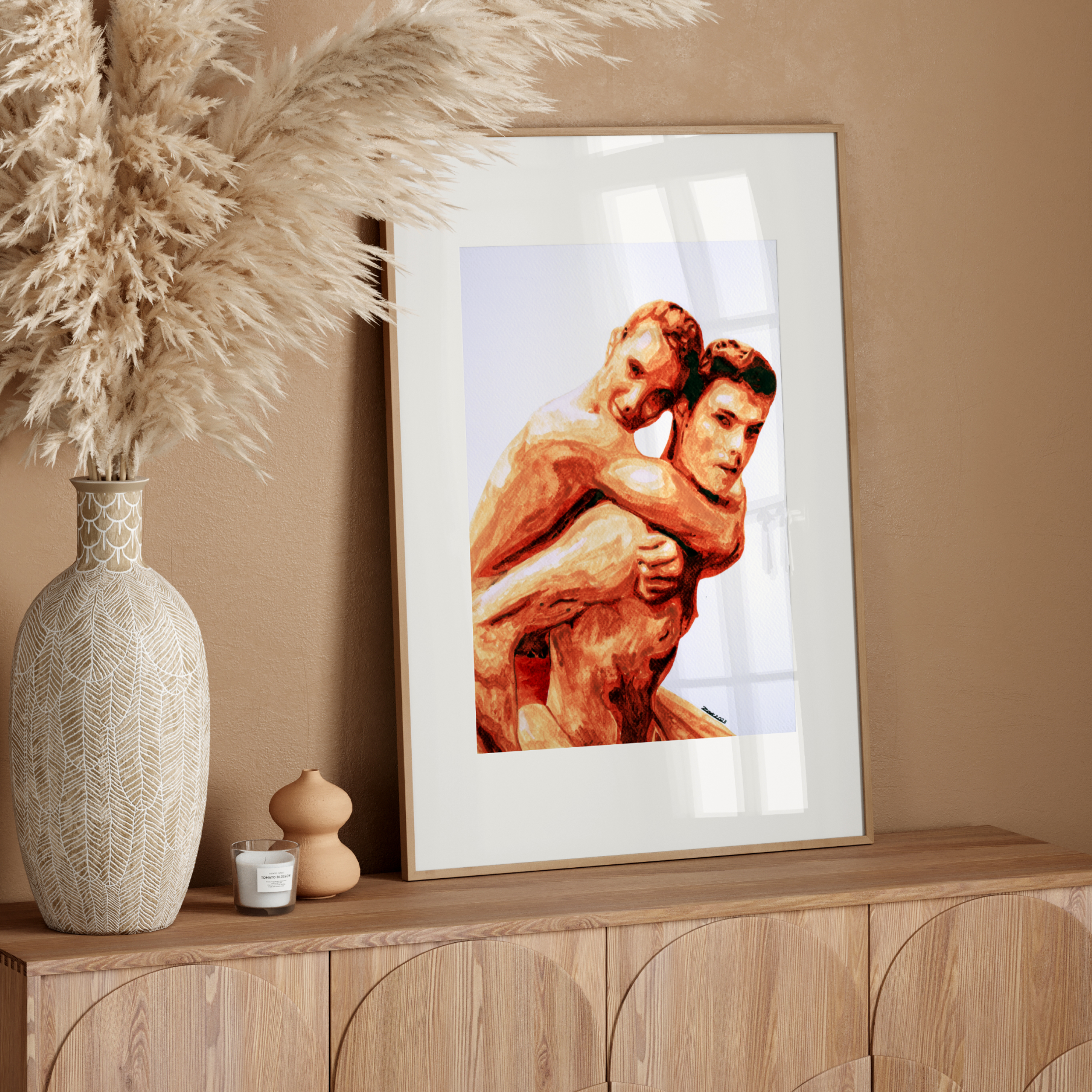 Framed artwork of two men embracing on a wooden sideboard with decorative elements.