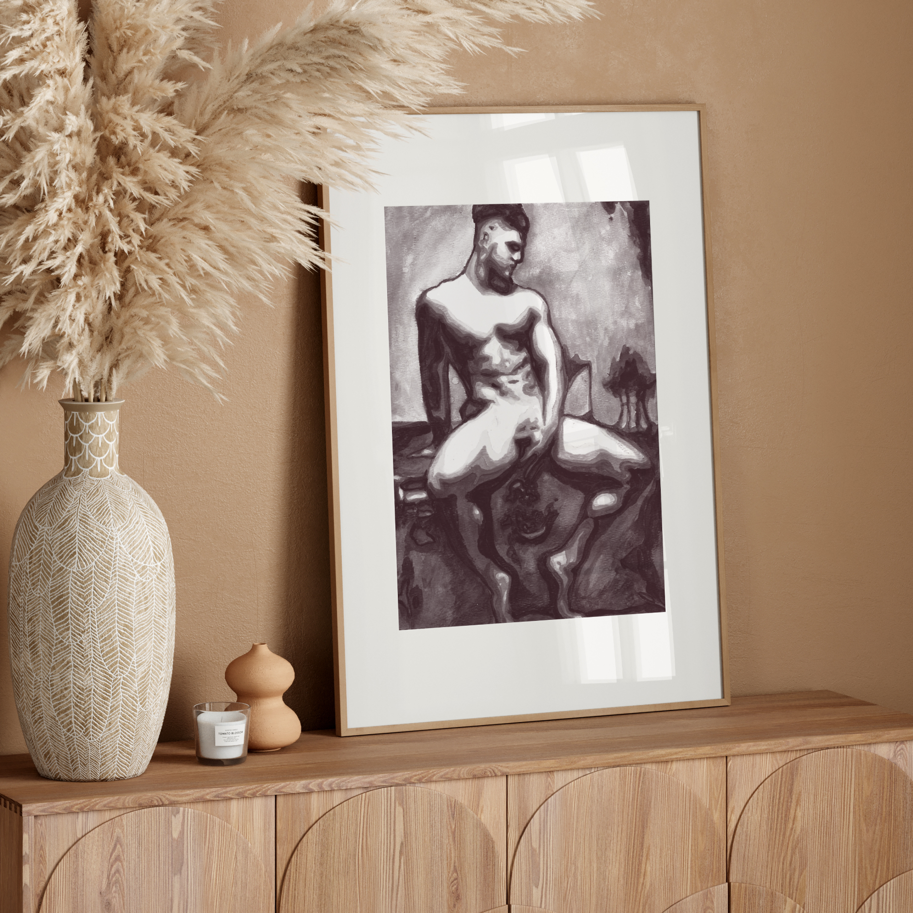 Framed artwork on a wooden console table with decorative elements against a beige wall.