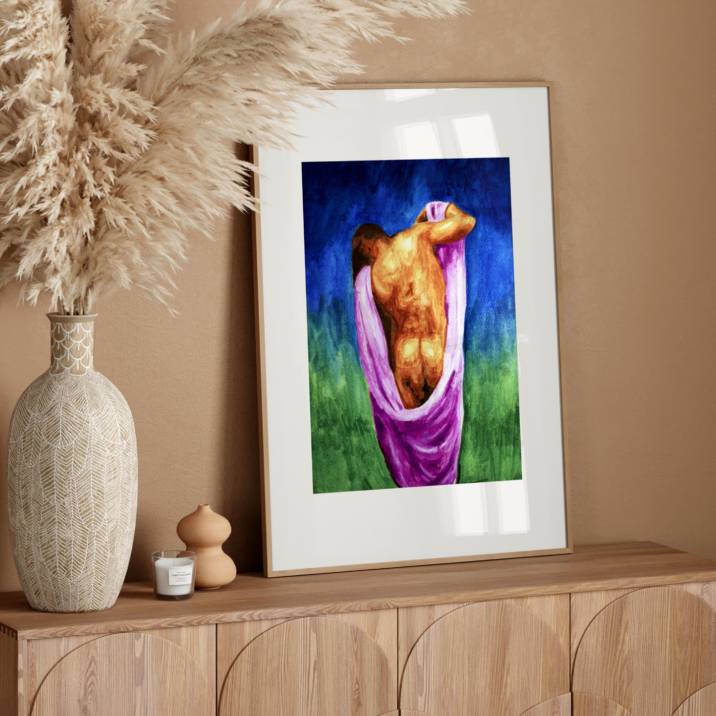 Framed artwork on a wooden console table with decorative elements.