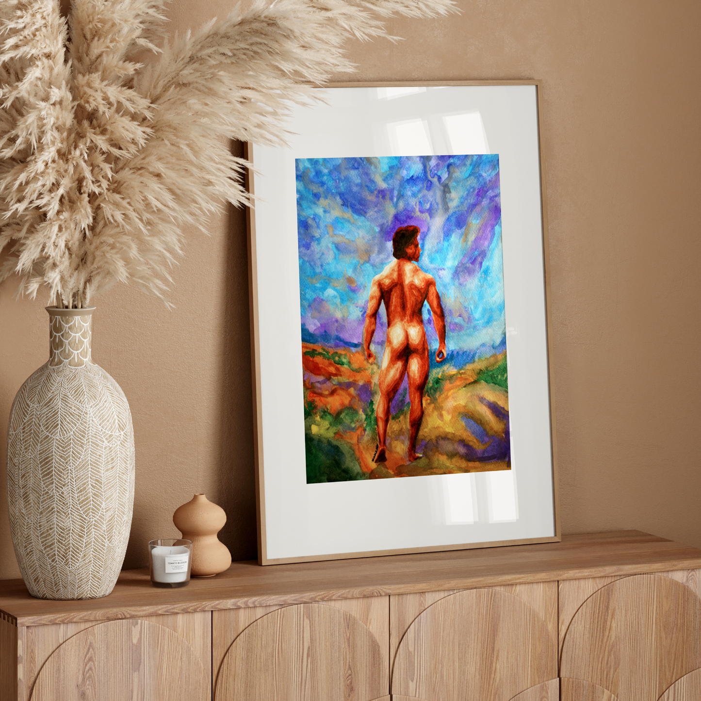Framed artwork of a nude figure on a wooden console table with decorative elements.