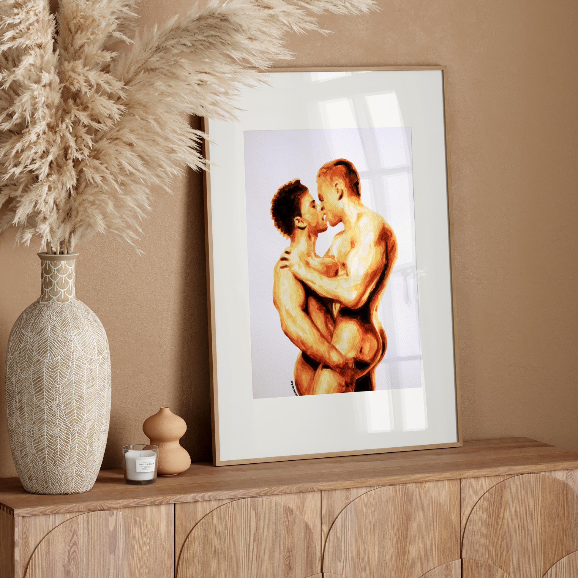 Framed artwork of two people embracing on a wooden sideboard with decorative elements.